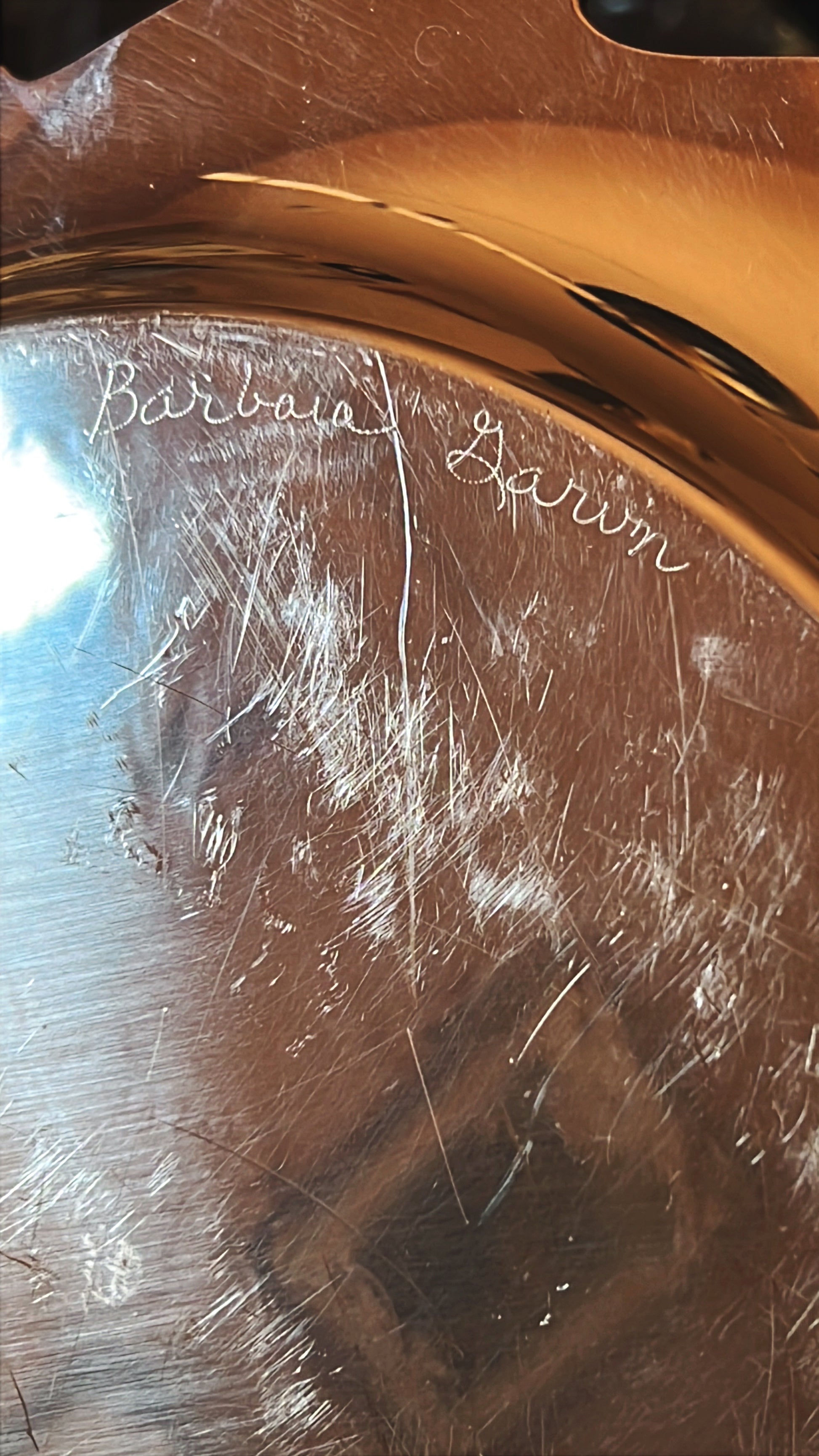 a name etched in the underside of a vintage silver tray