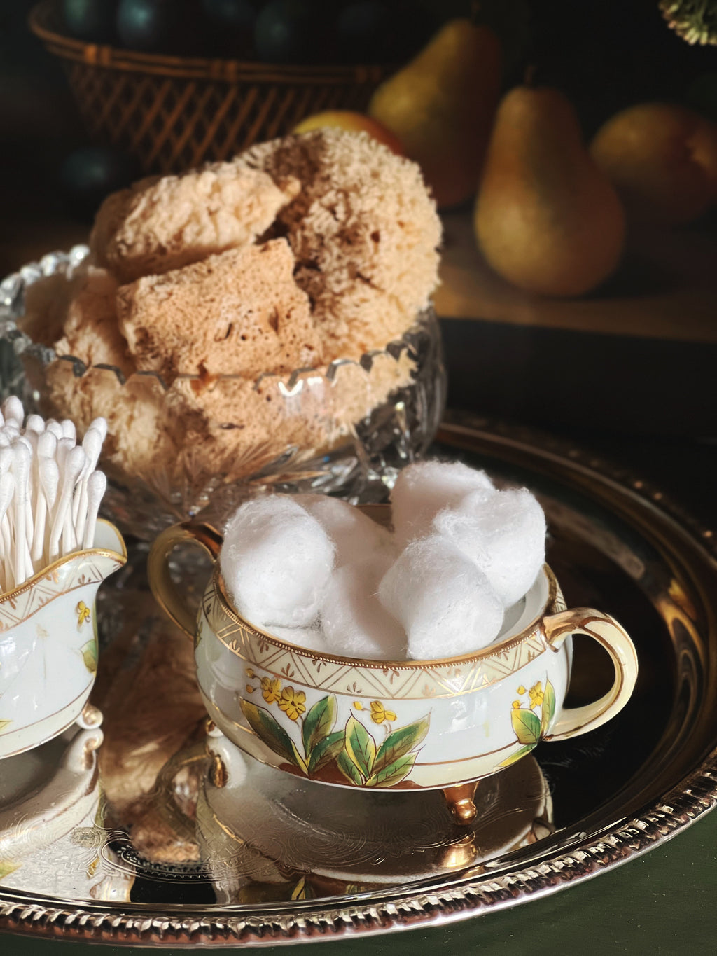Antique hand-painted Nippon sugar bowl with yellow floral details styled with cotton balls on a silver tray