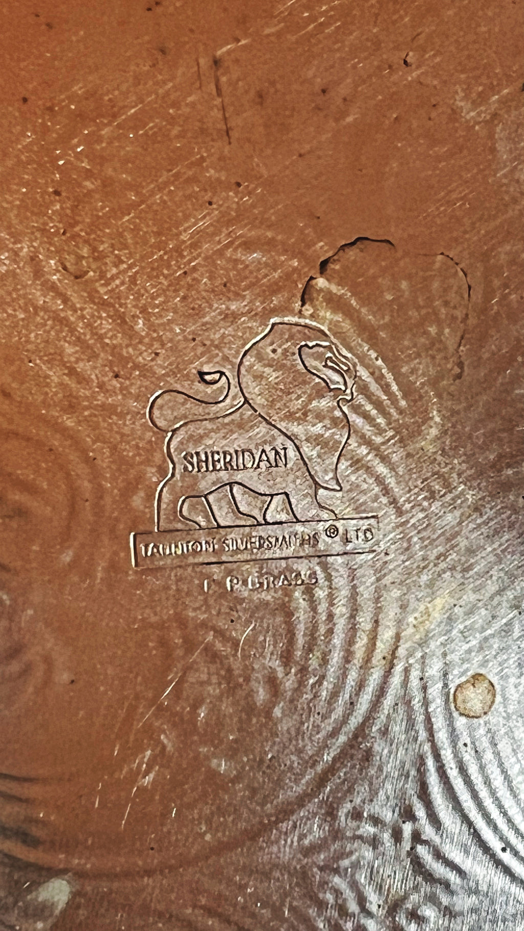 Close-up of a Sheridan logo on a textured surface