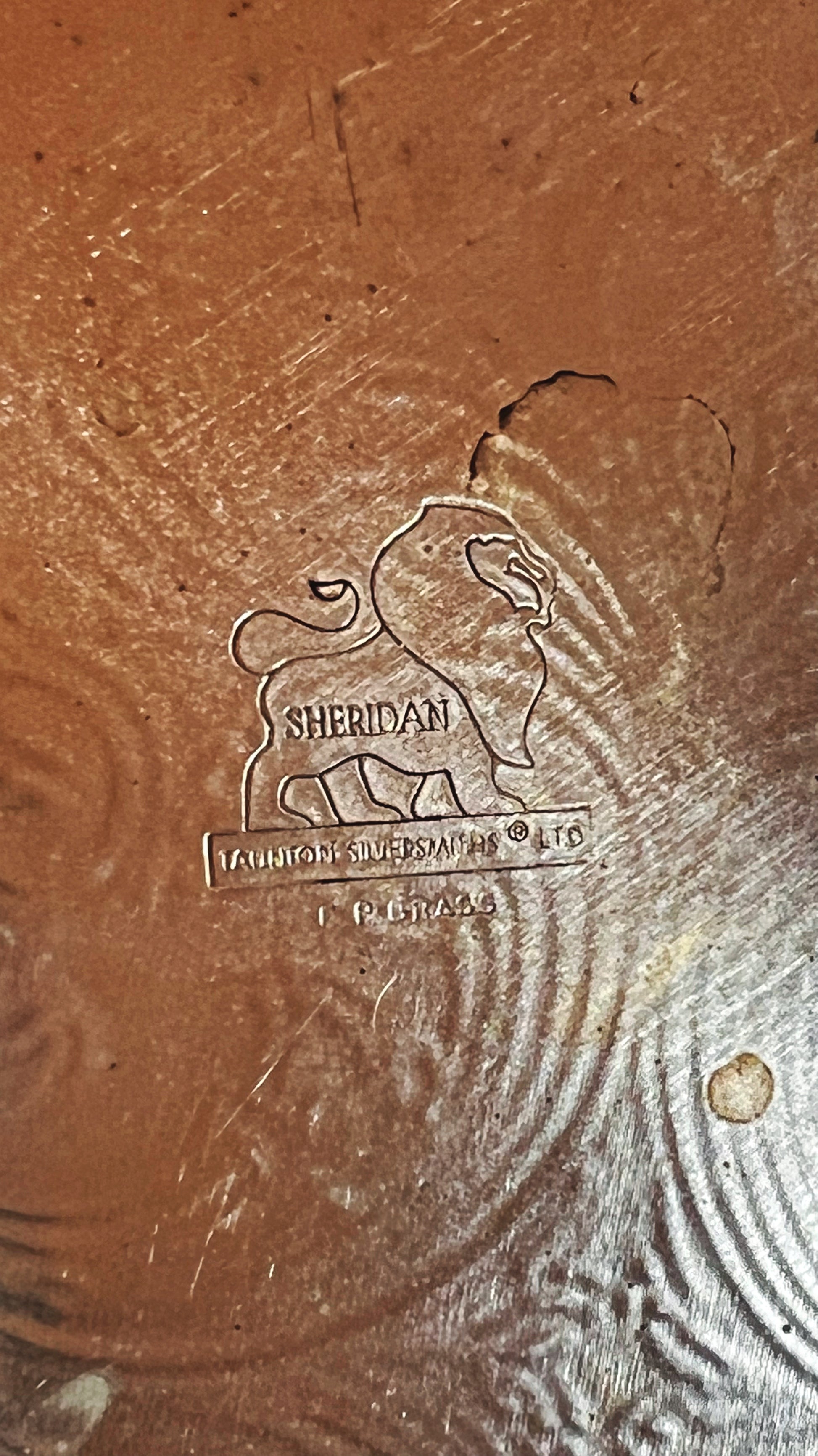Close-up of a Sheridan logo on a textured surface