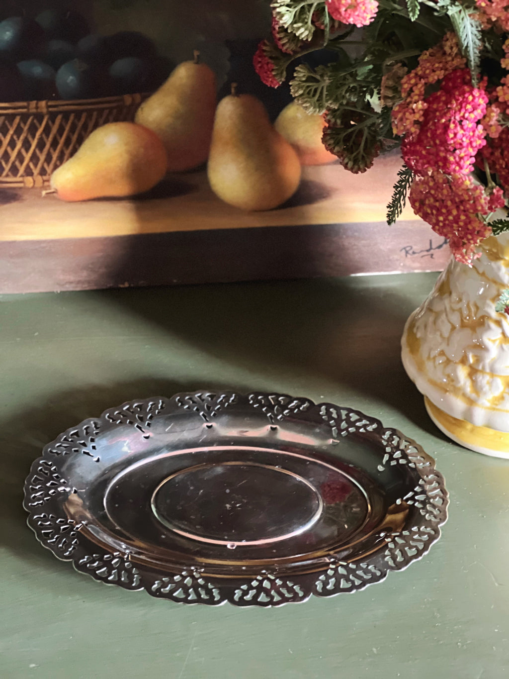 Overhead view of a small silver tray with pierced edge by Home Decorators Collection