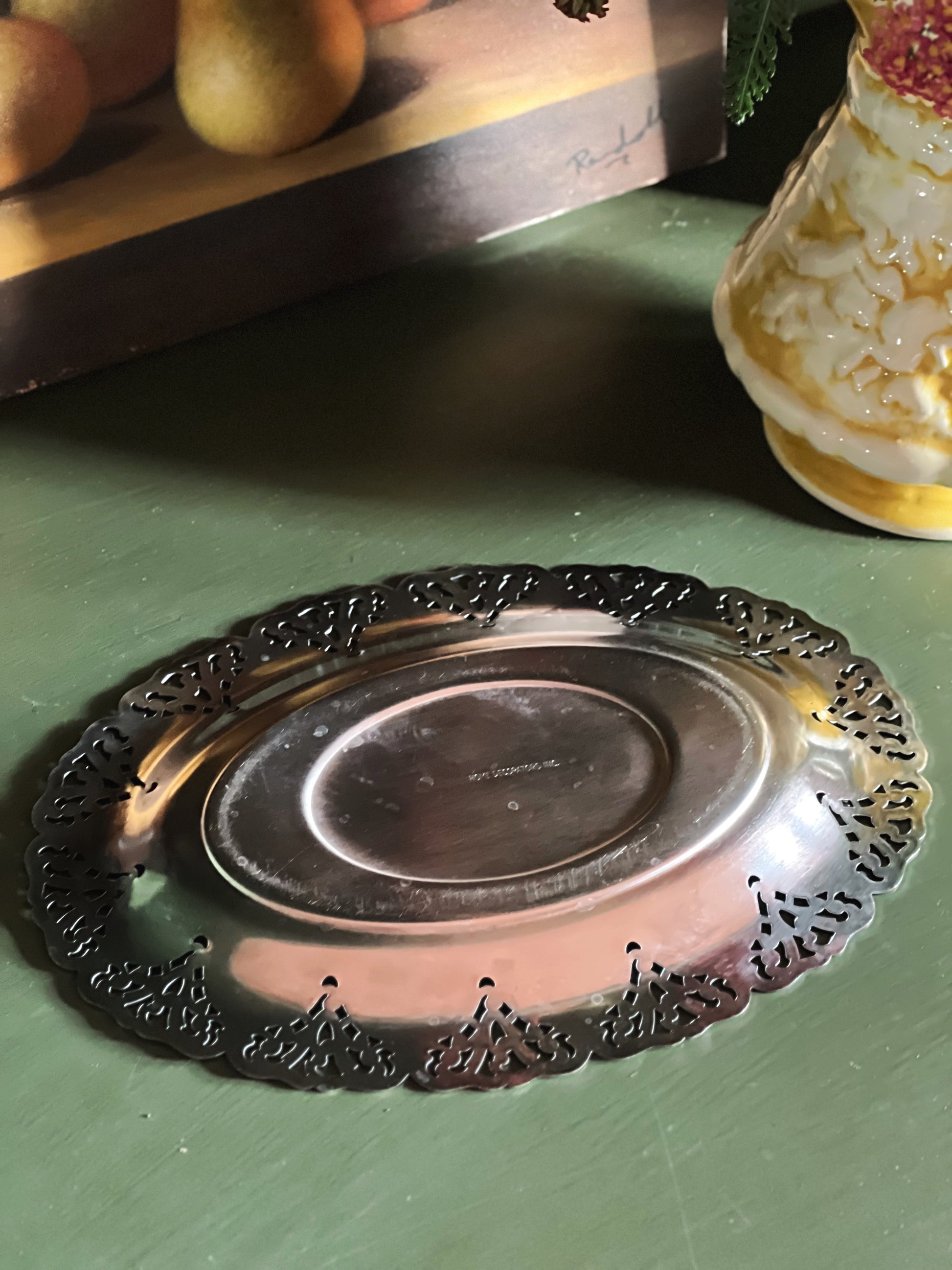 Underside of a small silver tray with pierced edge by Home Decorators Collection