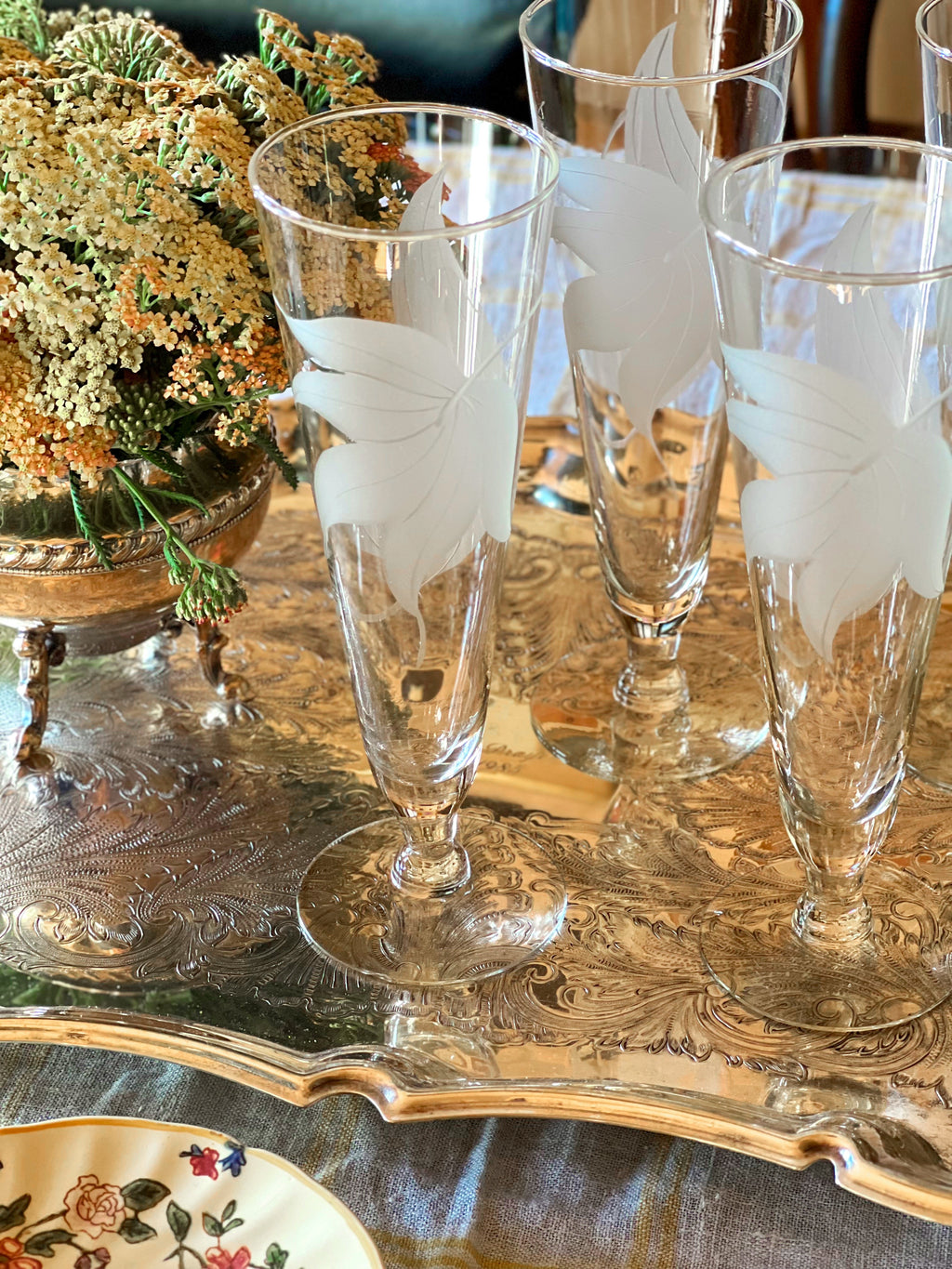 Elegant set of four vintage champagne flutes styled for entertaining.