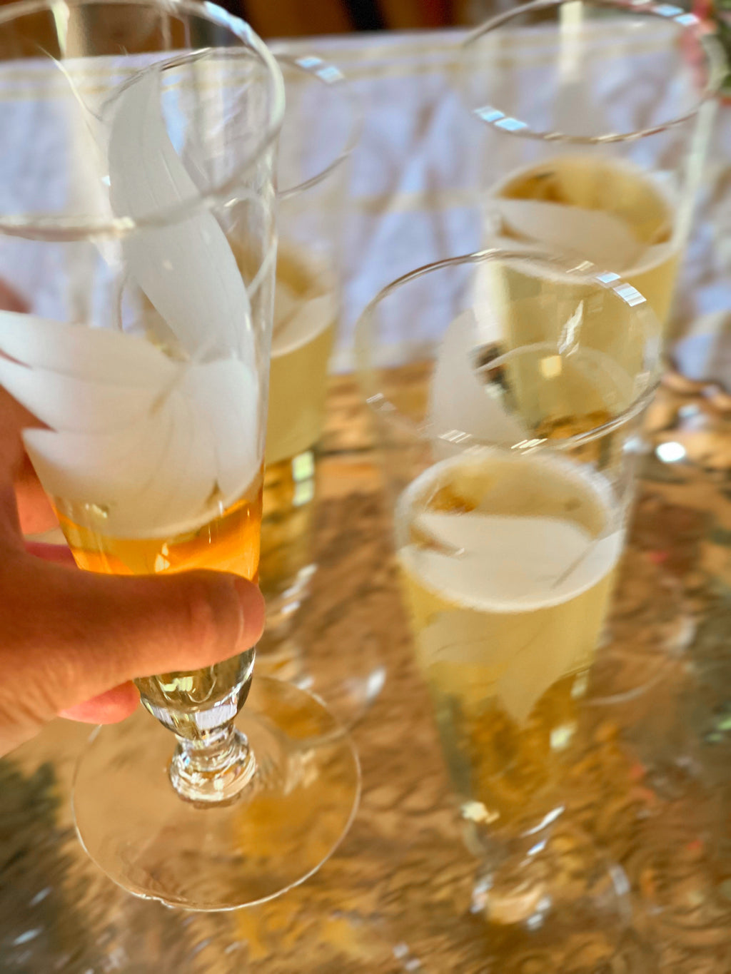 Close view of etched floral design on vintage stemware.