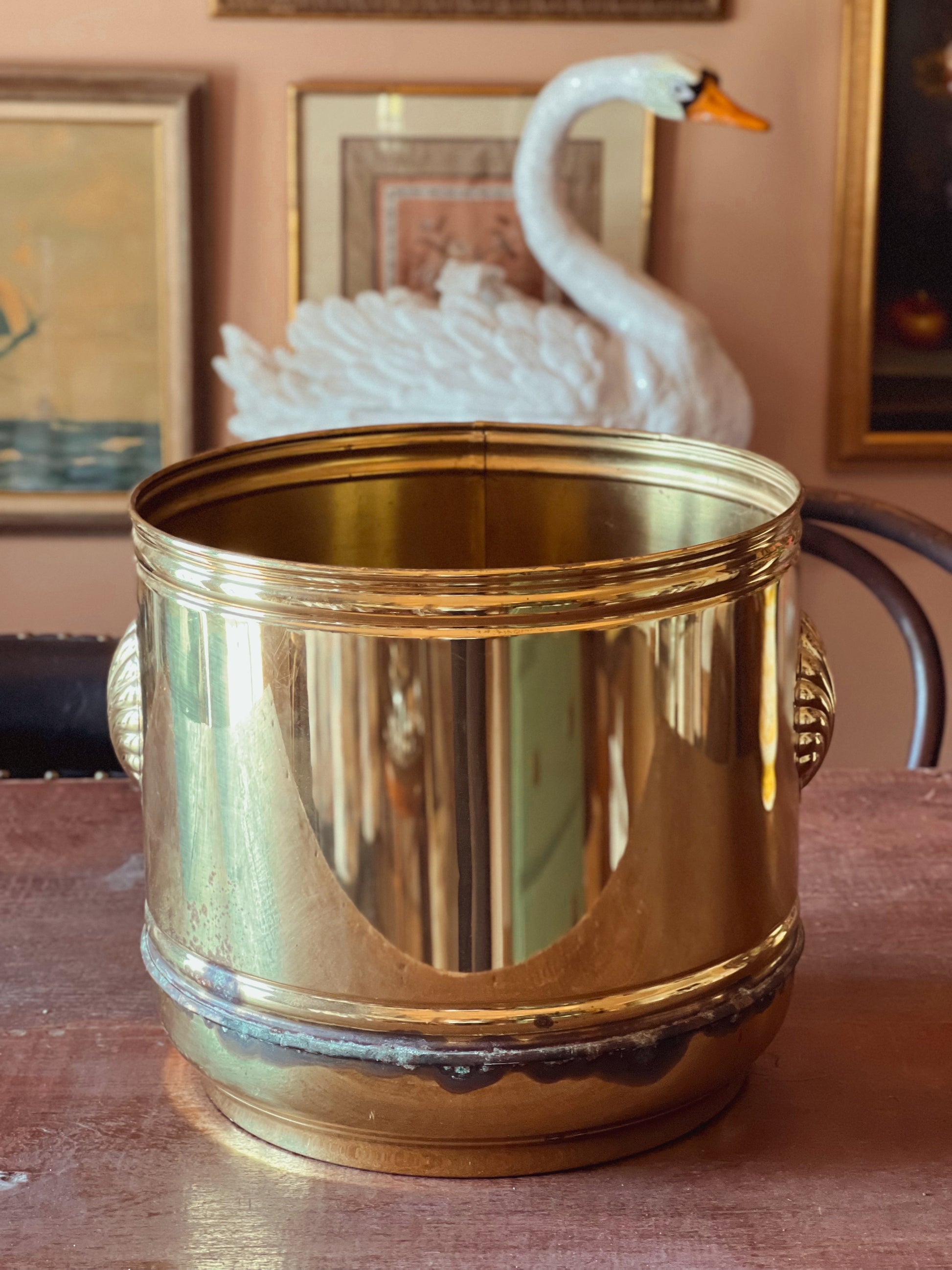 Side view of large vintage brass cachepot with aged patina.
