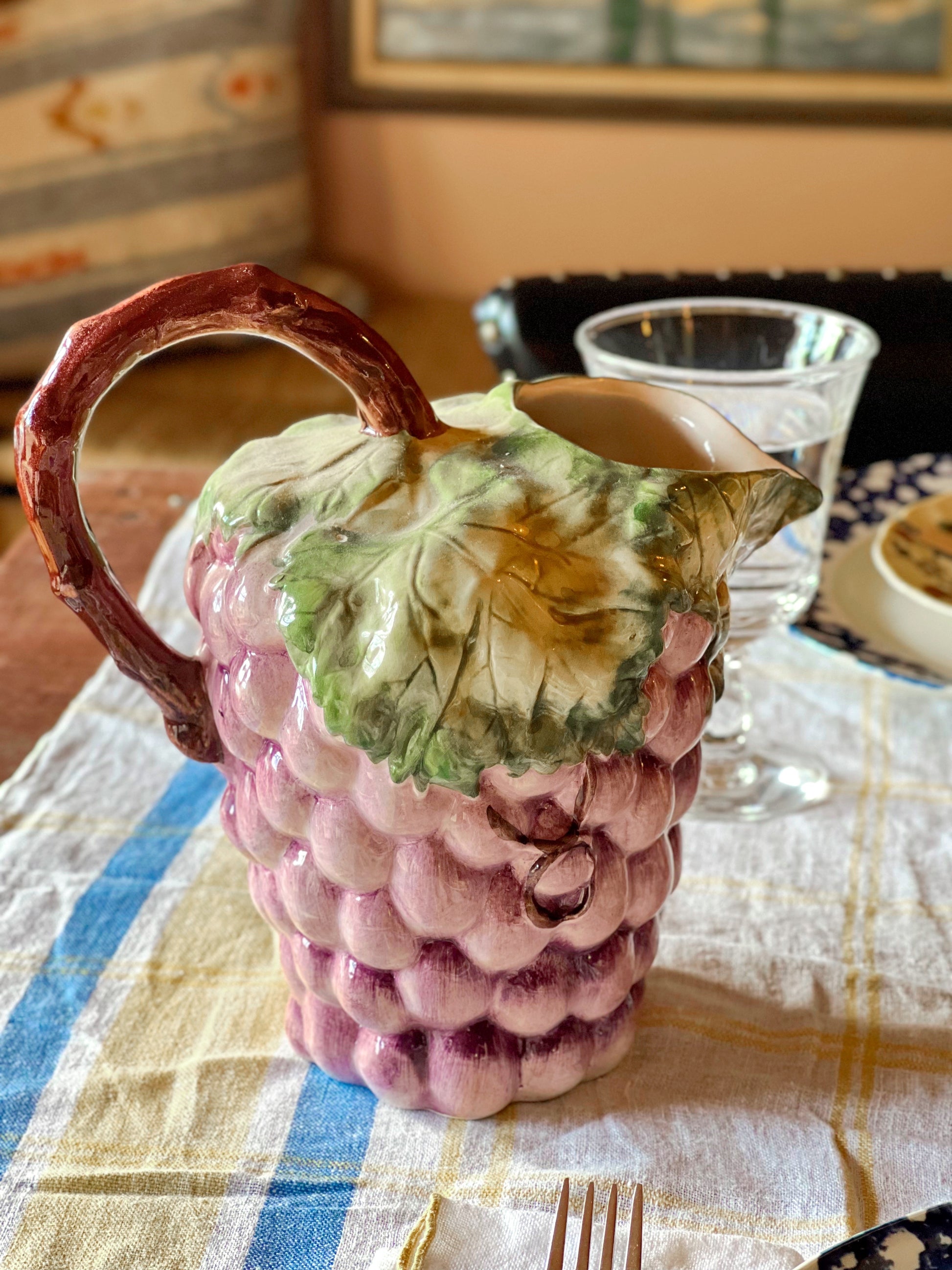 Decorative majolica grape pitcher on a summer table.