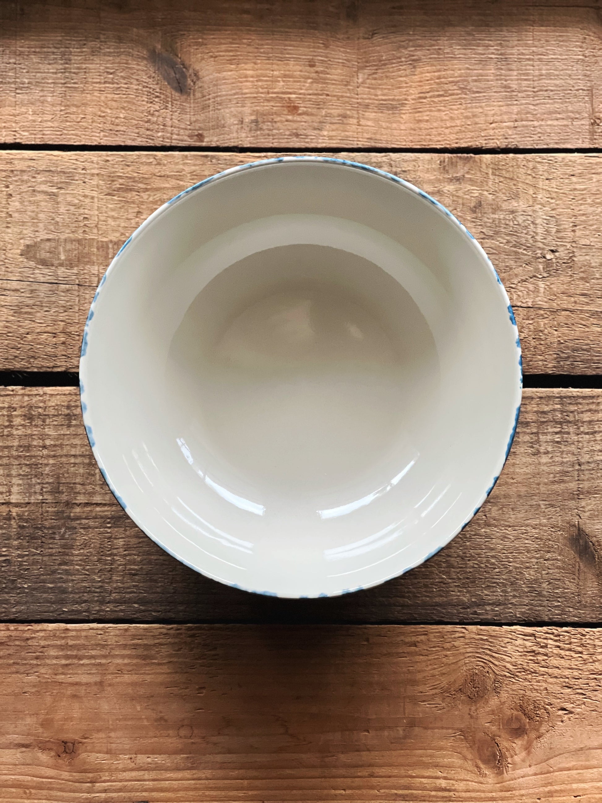 overhead view of a stoneware bowl on a wooden surface