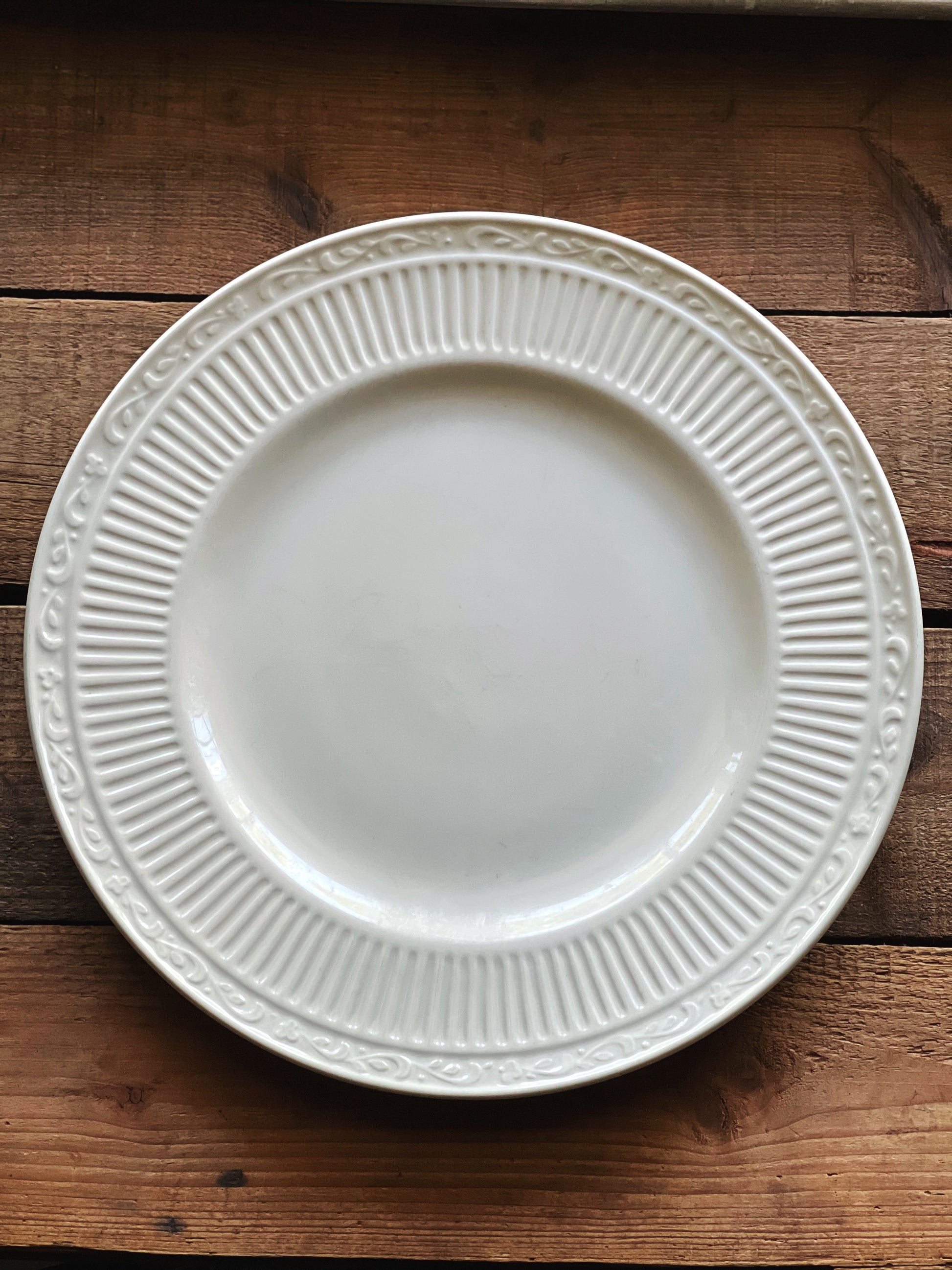 Mikasa Italian Countryside dinner plate on a rustic wood surface