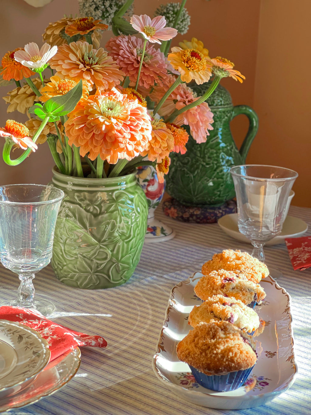 Table setting with a Franciscan Ivy II kitchen canister, muffins, flowers, and green teapot in a home decor setting.