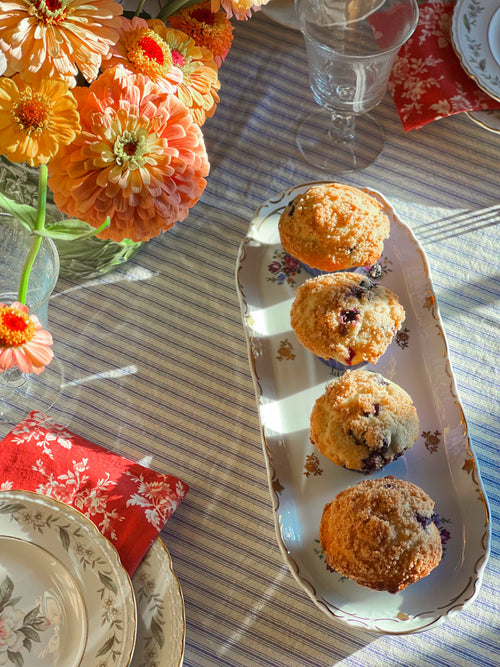 Blueberry muffins on a Reichenbach East German tray with flowers and tableware in the background
