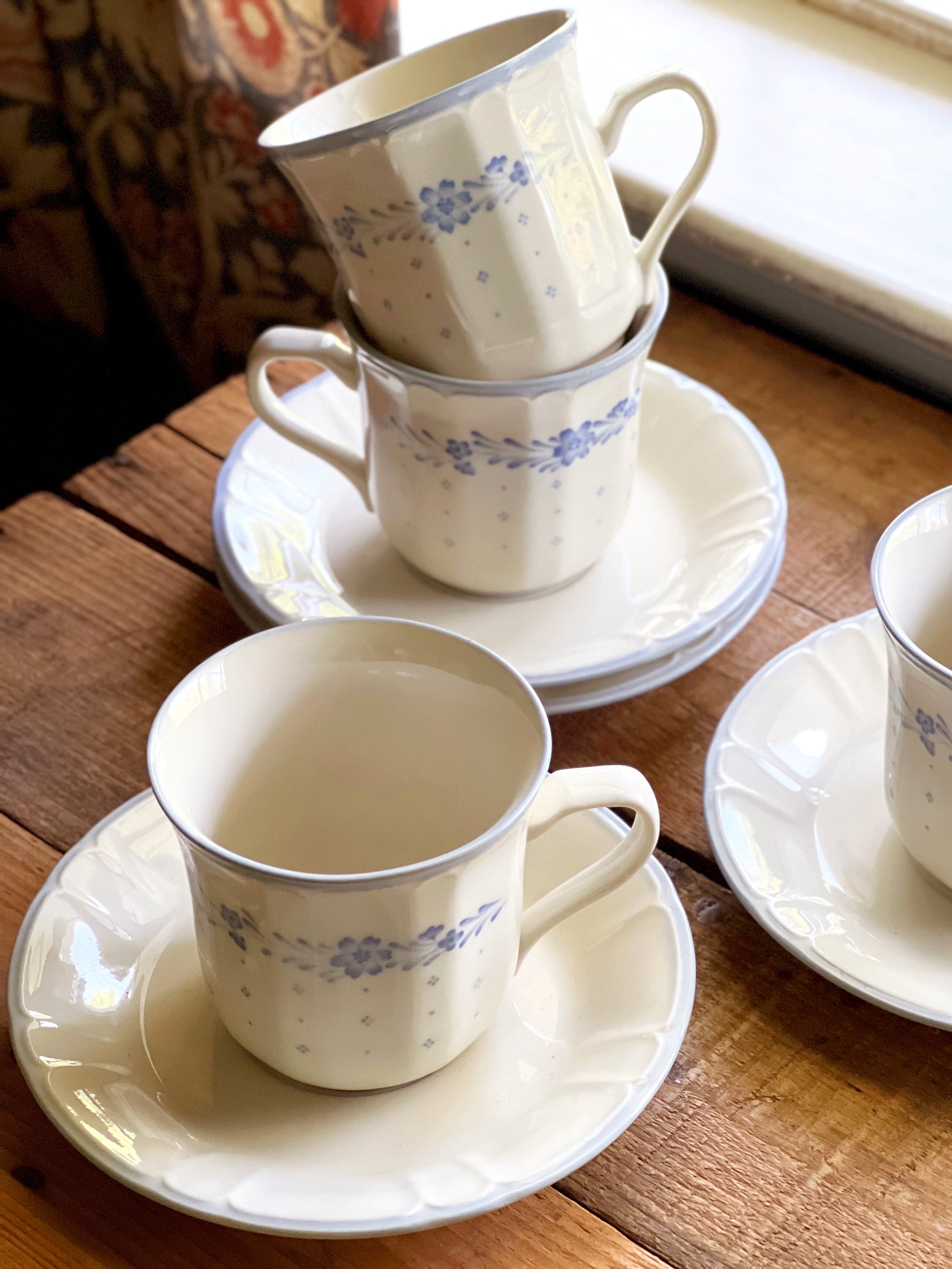 overhead view of a set of Sango Arcadia Blue teacup and saucer sets