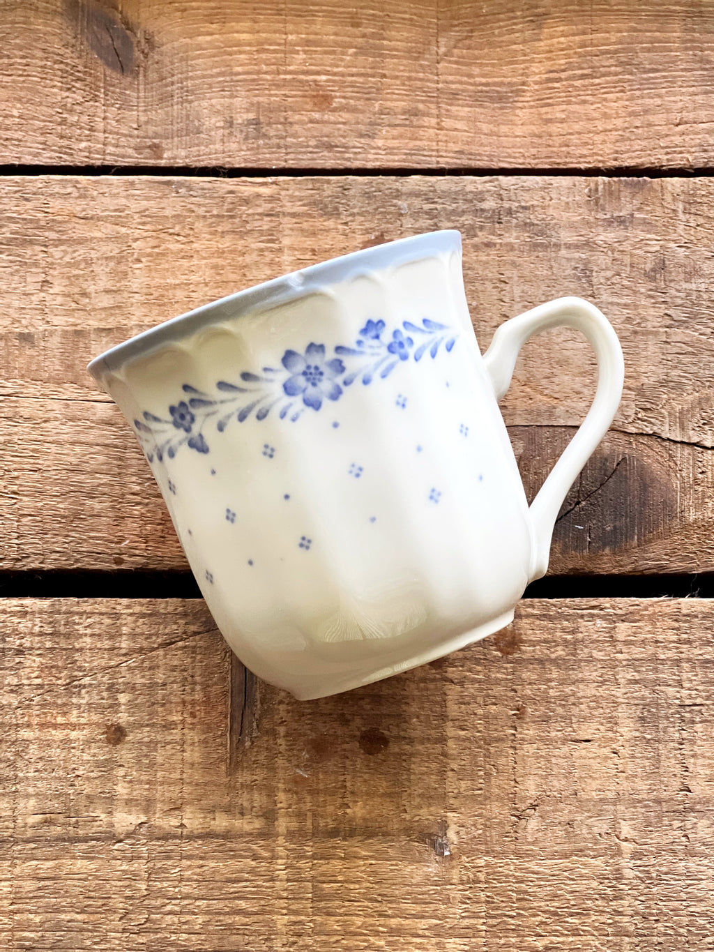 Sango Arcadia Blue mug with a small chip on the rim