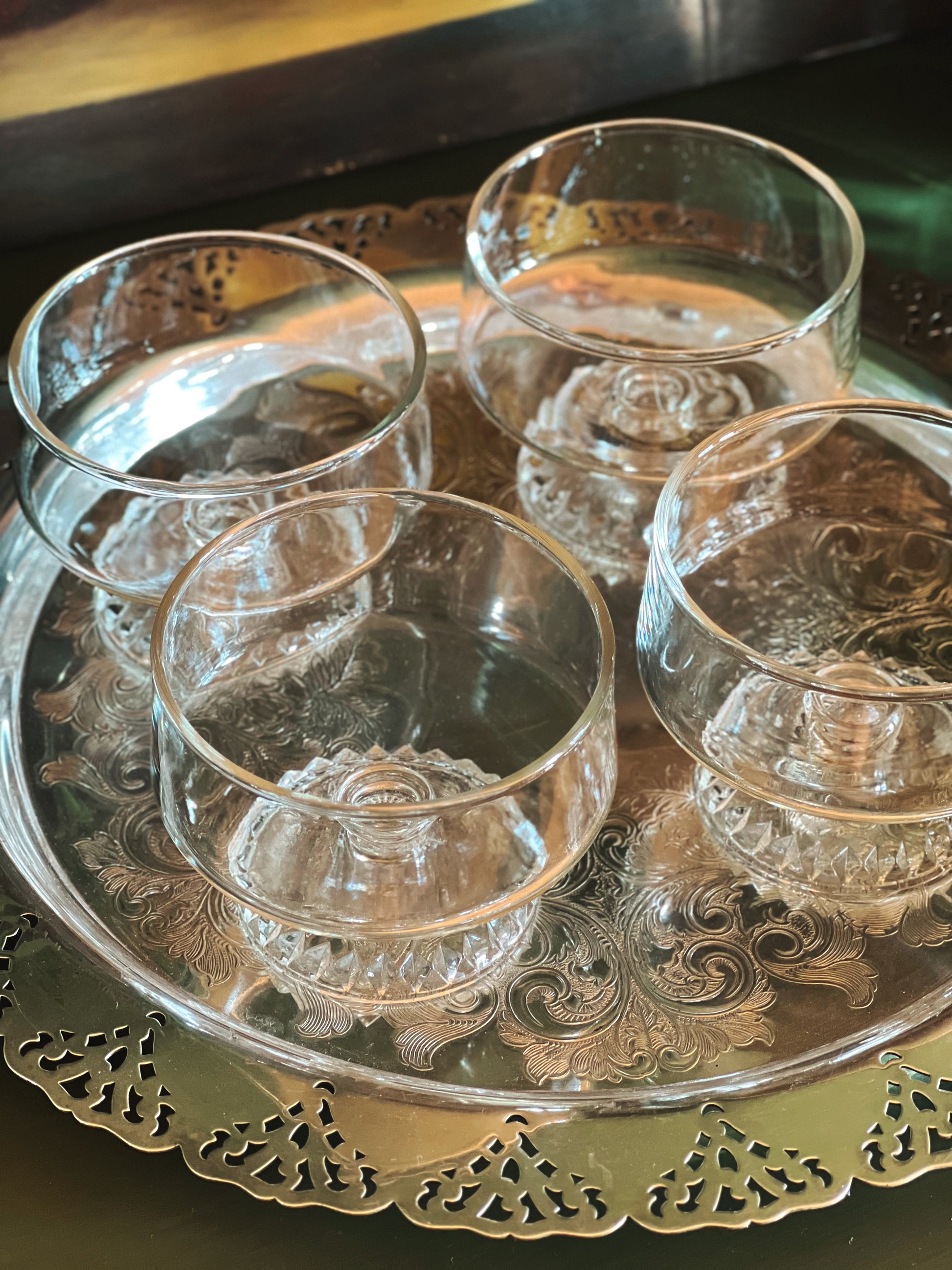 Vintage coupe glasses displayed on a silver tray 