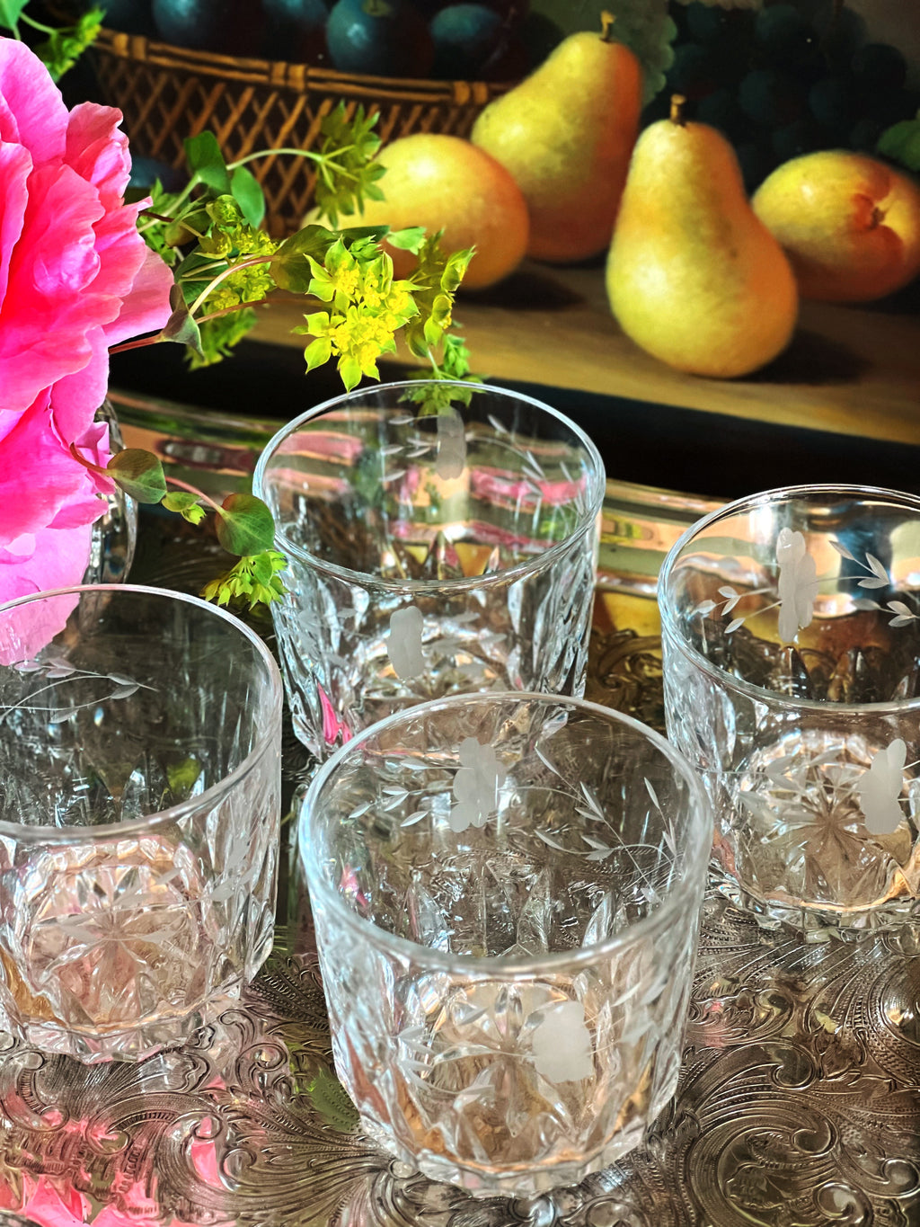 Overhead view of a set of four vintage etched crystal double old fashioned glasses 