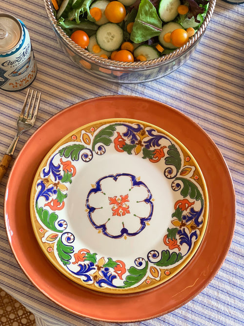 Colorful CMG Portugal ceramic luncheon plate featuring a Mediterranean-inspired floral motif and terracotta border.
