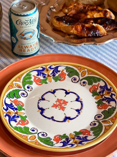 Colorful CMG Portugal ceramic luncheon plate featuring a Mediterranean-inspired floral motif and terracotta border.