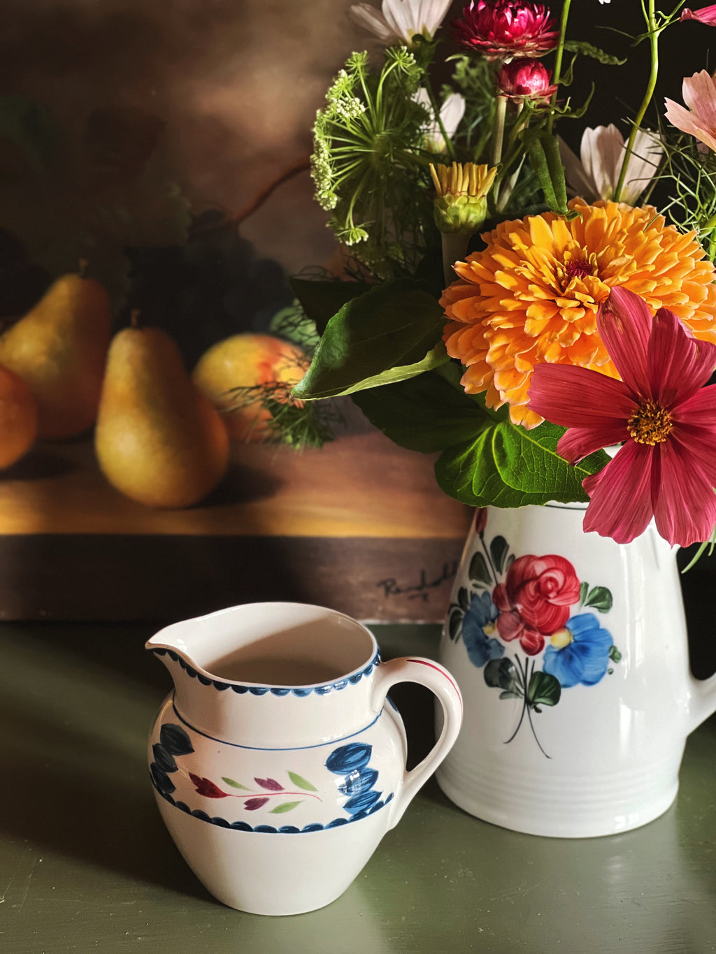 Vintage Adams Lancaster hand-painted English creamer styled beside garden flowers and pears in warm natural light.