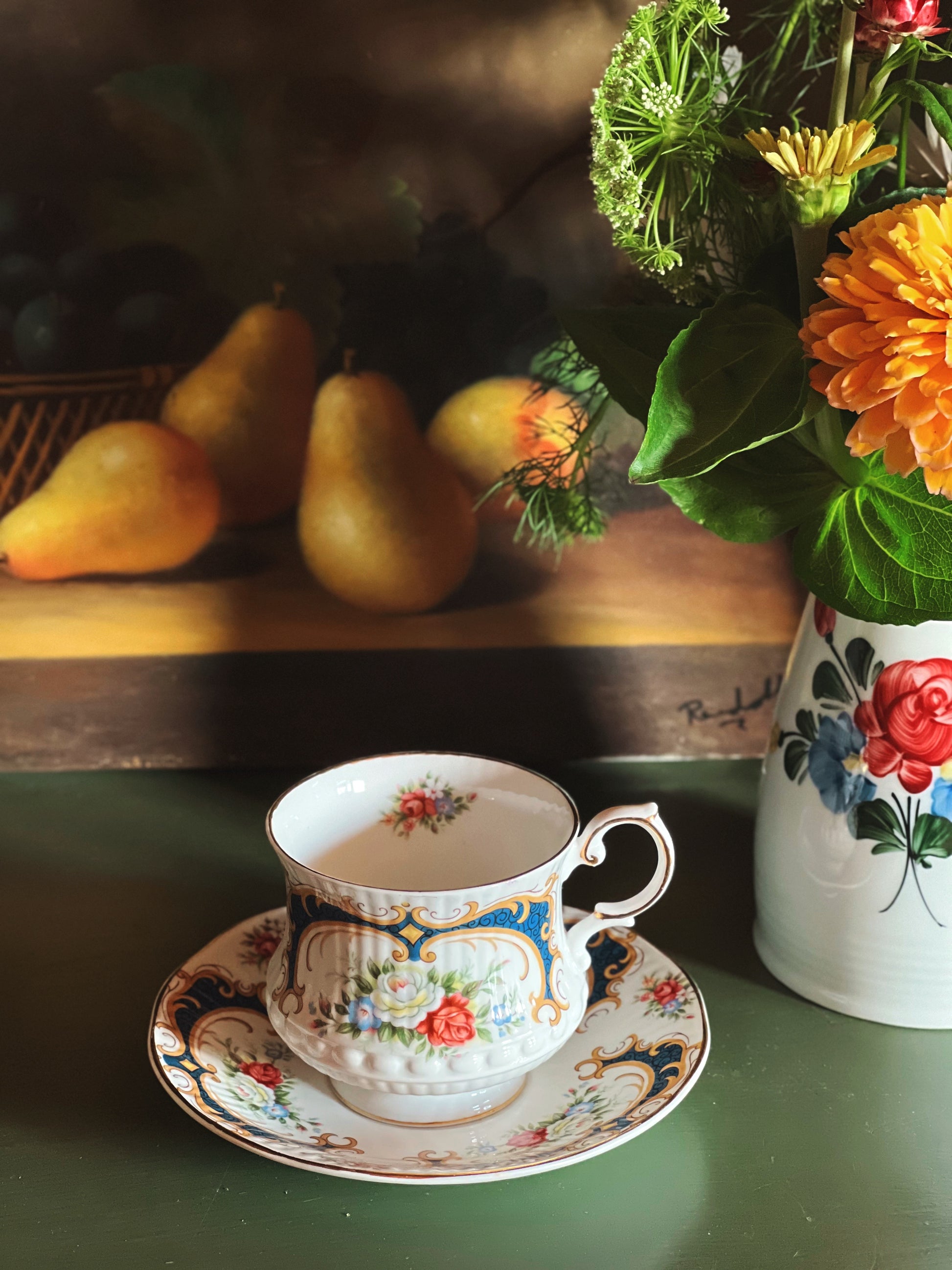 Vintage Queen’s Rosina bone china teacup and saucer with pink floral pattern, navy blue accents, and gold trim 