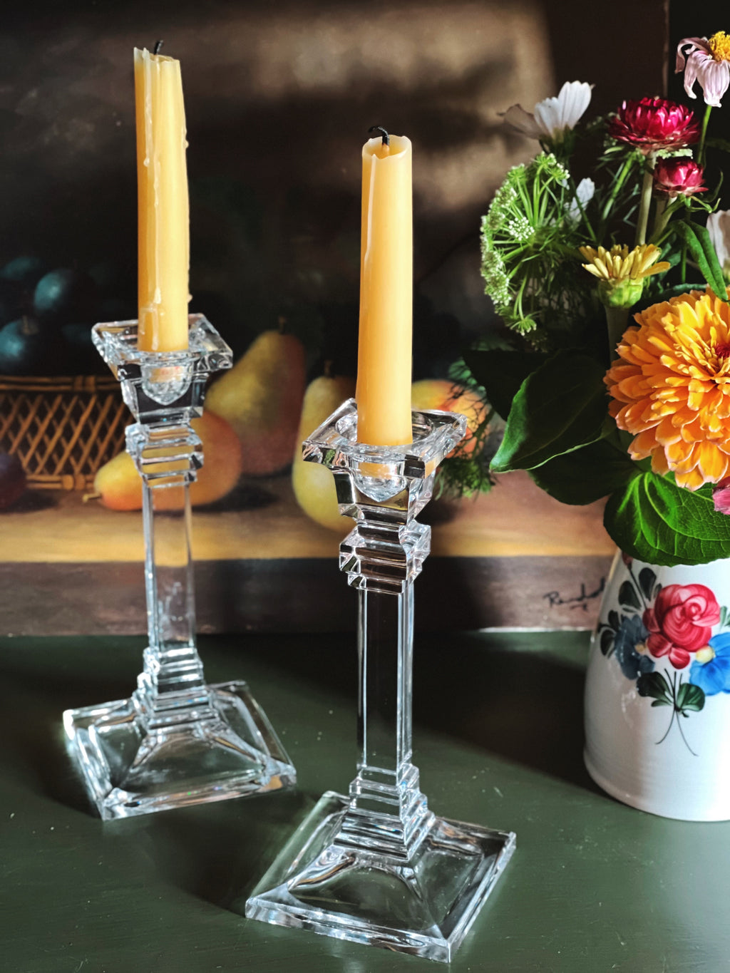 A timeless pair of crystal candlesticks with clean lines and striking square bases.