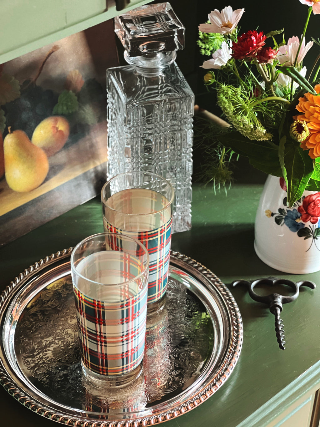 Overhead view of a pair of Ralph Lauren heritage plaid highball glasses on a silver tray