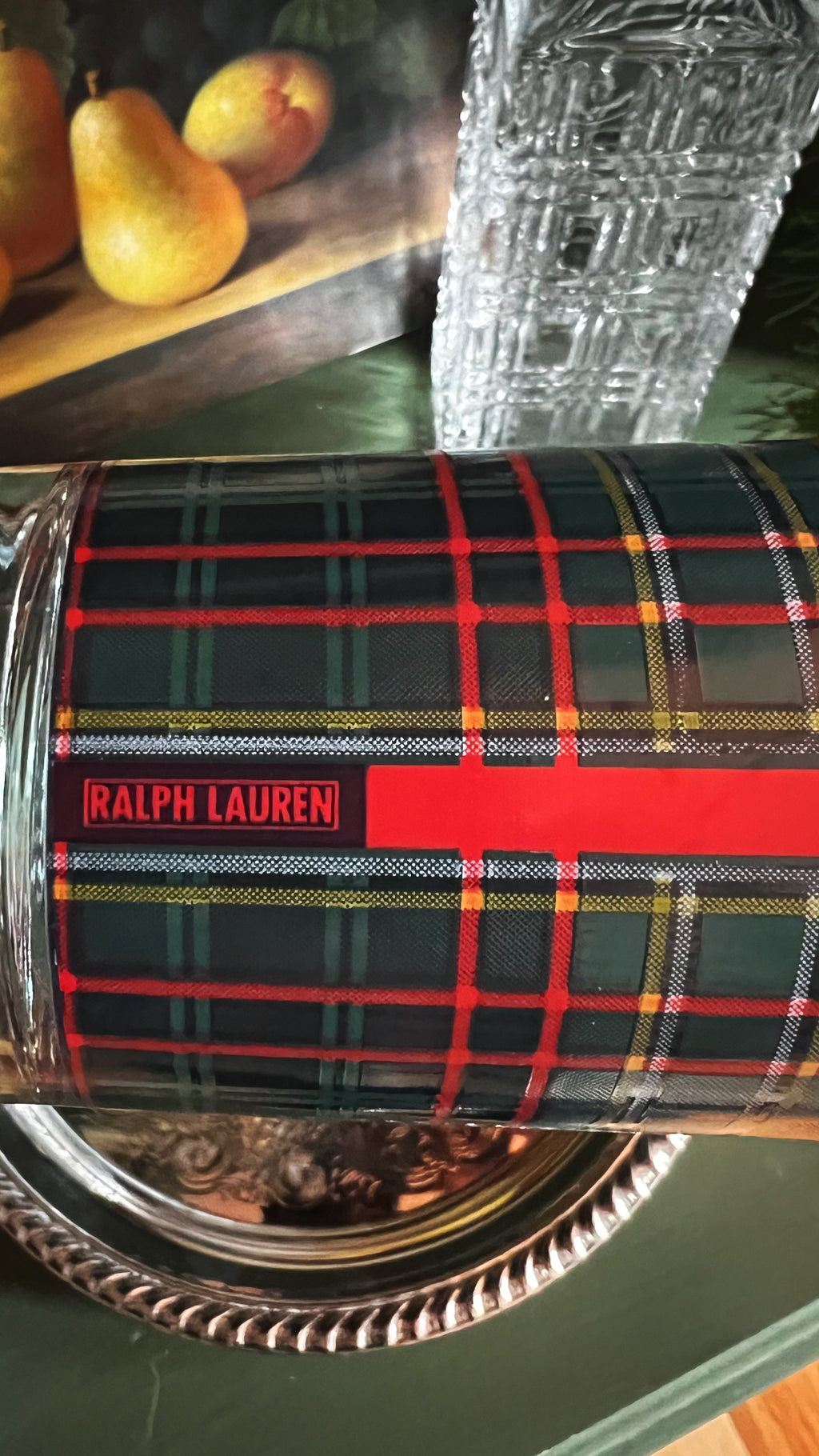 Plaid-patterned tumbler with Ralph Lauren logo on a green surface