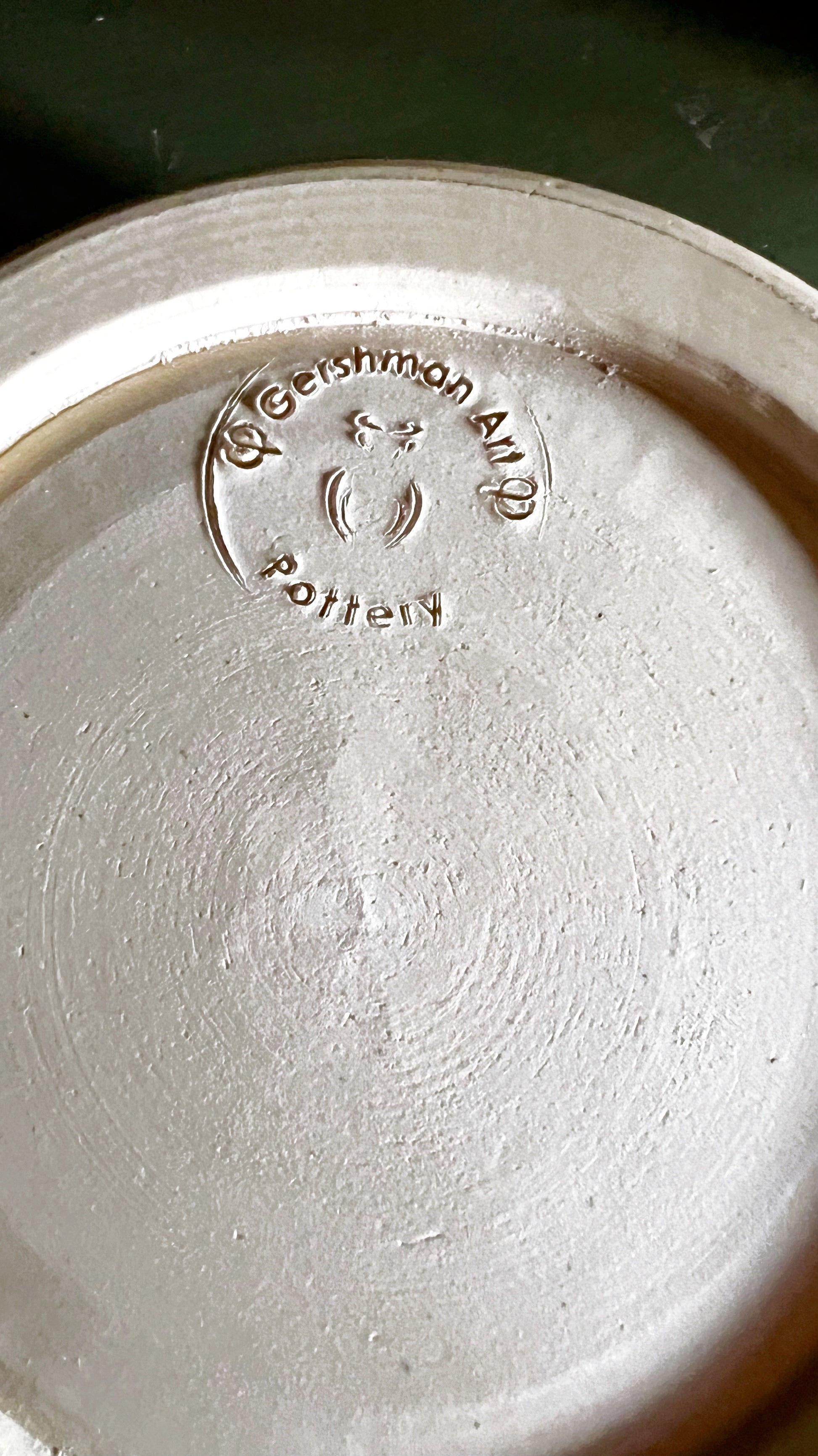 Close-up of a ceramic bowl with 'Gershman Art Pottery' branding.
