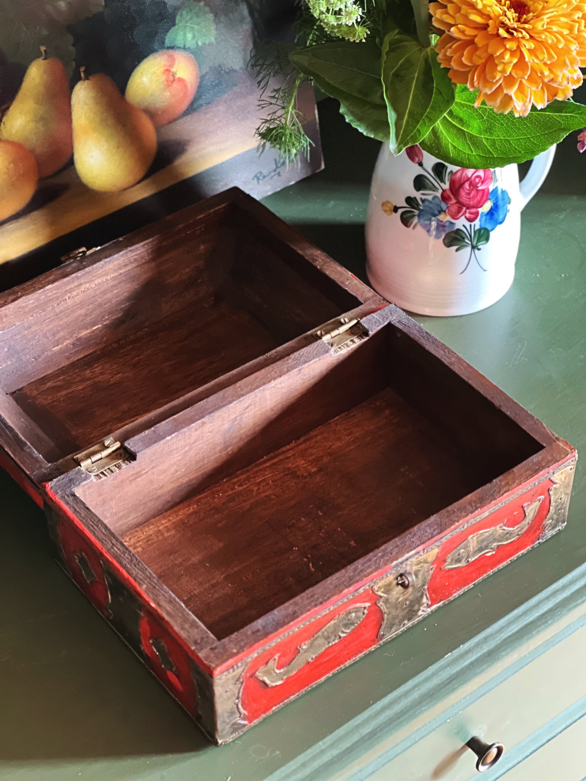 Open vintage wooden jewelry box showing spacious interior