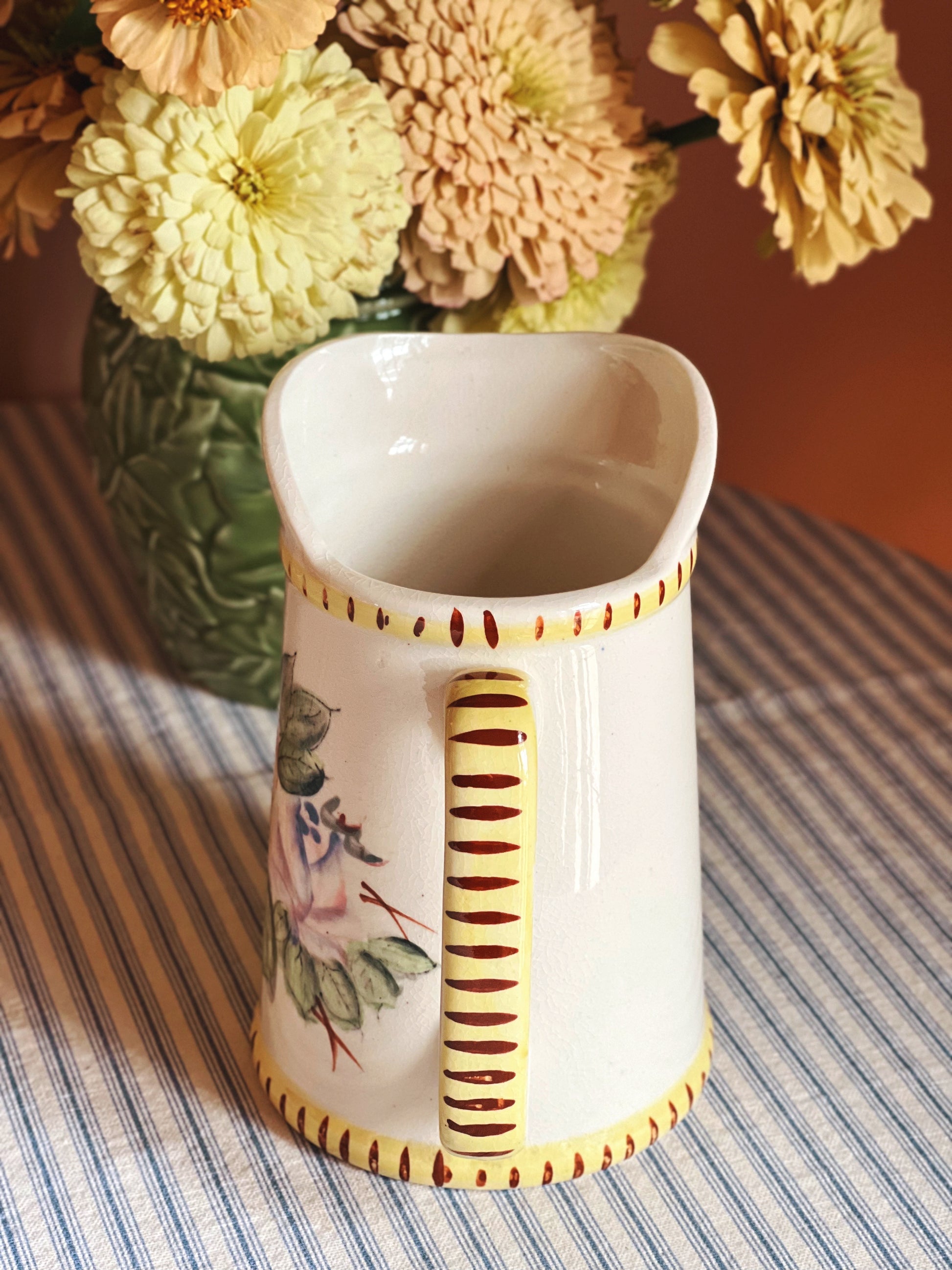 Handle detail of a Vintage Hand Painted Ceramic Batter Pitcher