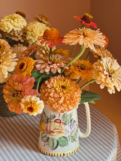 Vintage Hand Painted Ceramic Batter Pitcher filled with an arrangement of zinnias