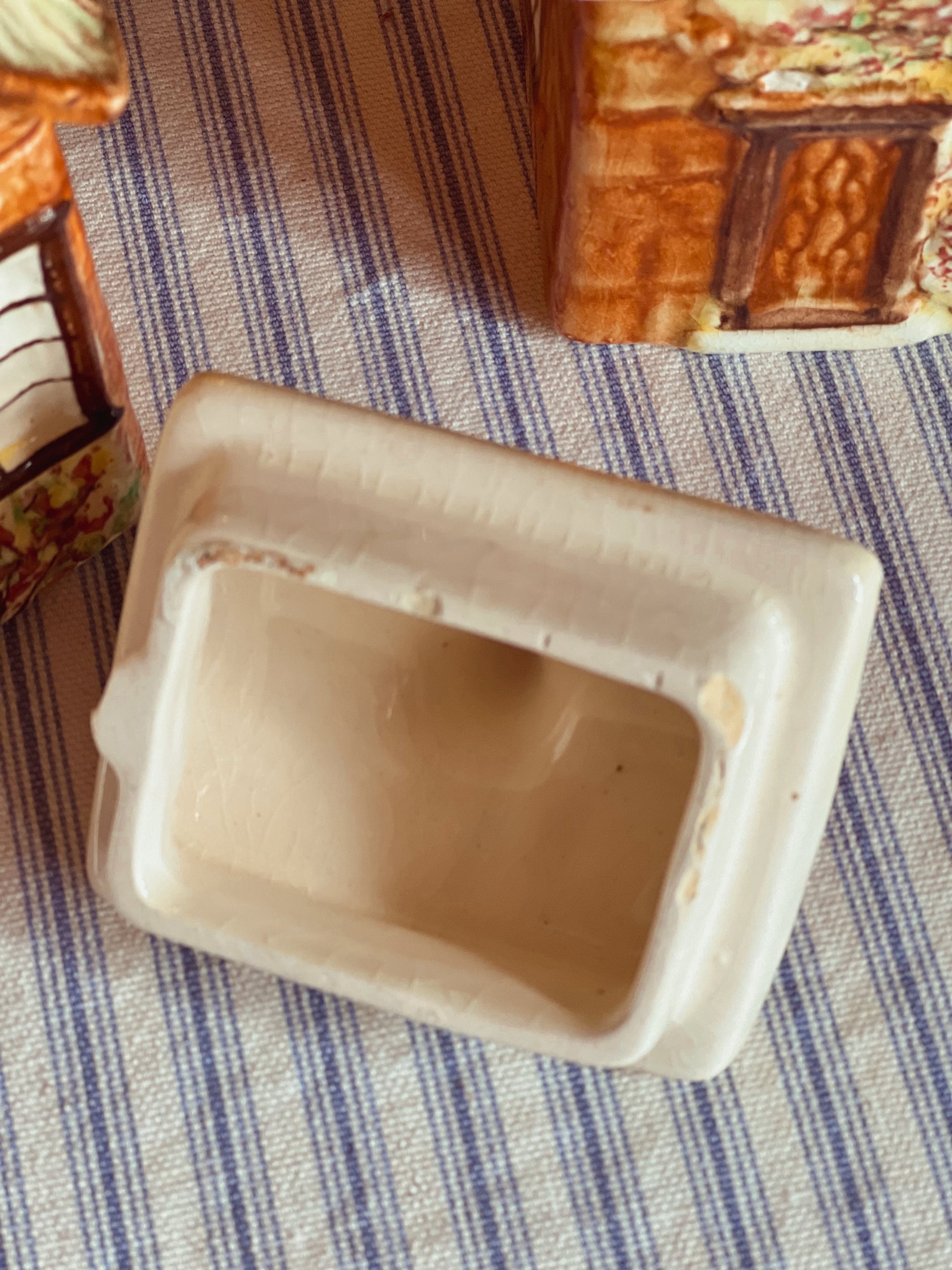 visible chips on the lid of a vintage cottage teapot