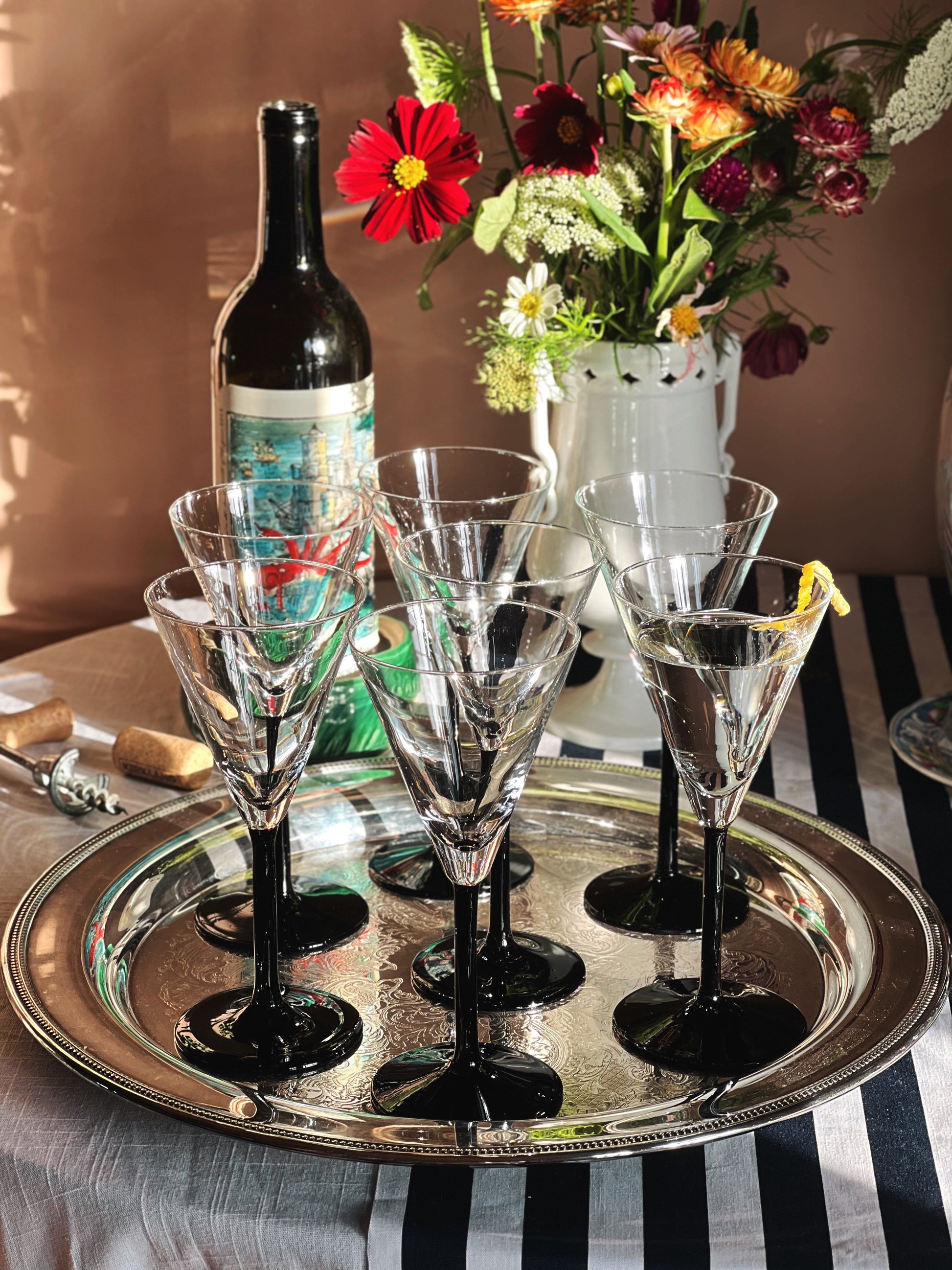 Vintage Crystal Martini Glass with Black Stem on a silver tray with a striped tablecloth