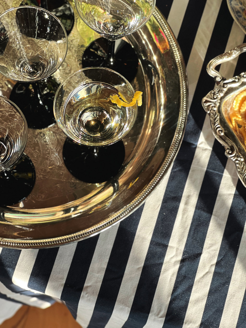 Vintage Oneida Silverplate Round Serving Tray with martini glasses on a striped tablecloth