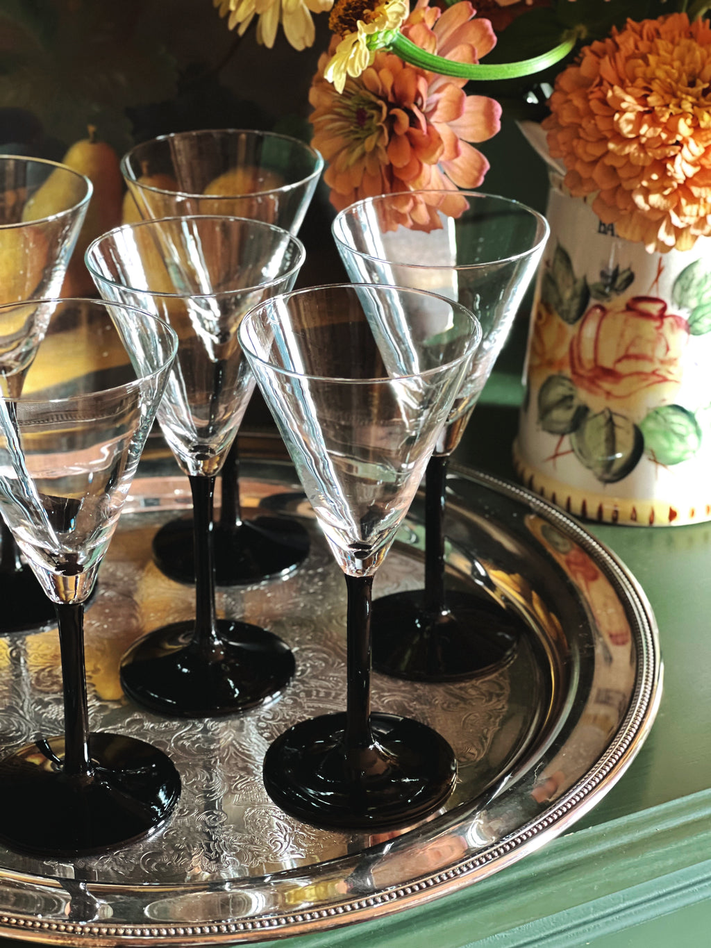 close up of Vintage Crystal Martini Glasses with Black Stems on a silver tray 