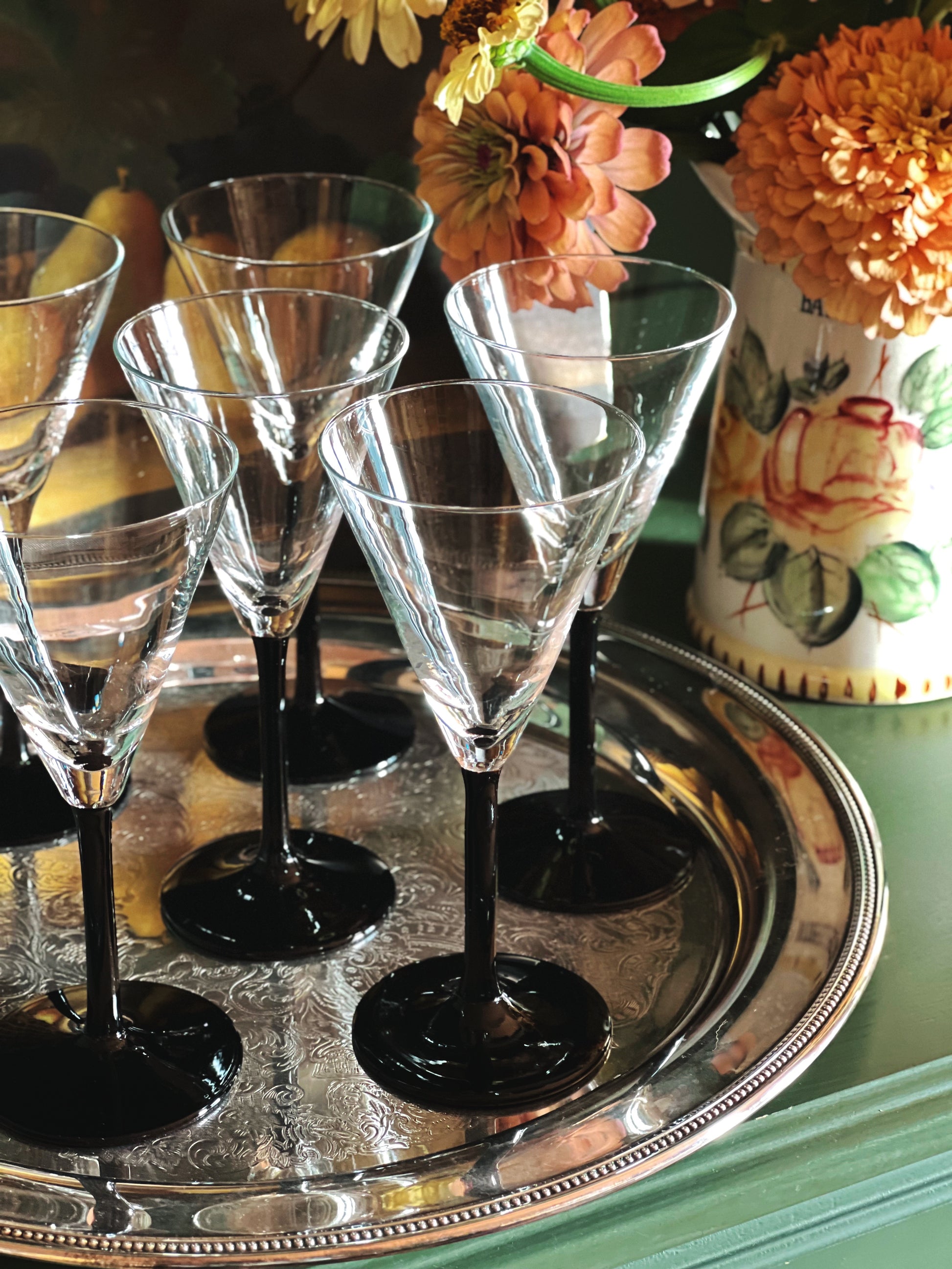 close up of Vintage Crystal Martini Glasses with Black Stems on a silver tray 