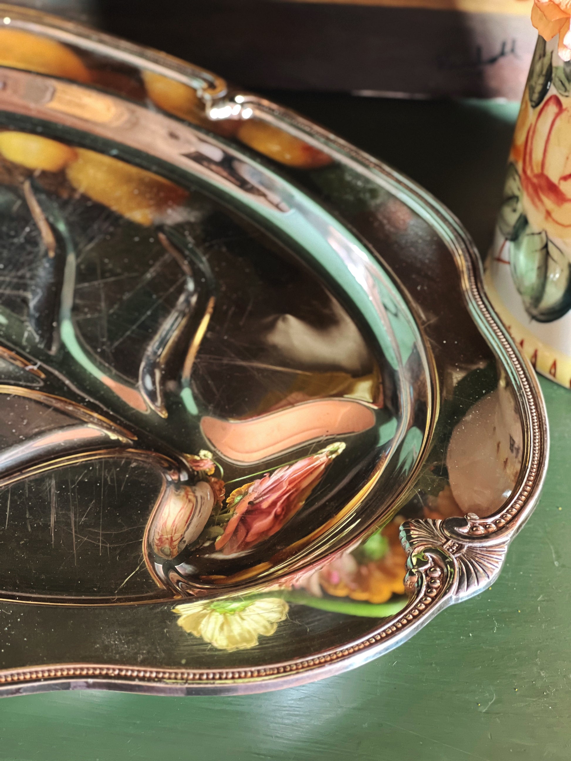rim detail of a Vintage International Silver Moonbeam Silver Plate 4-Toed Meat Platter with Well
