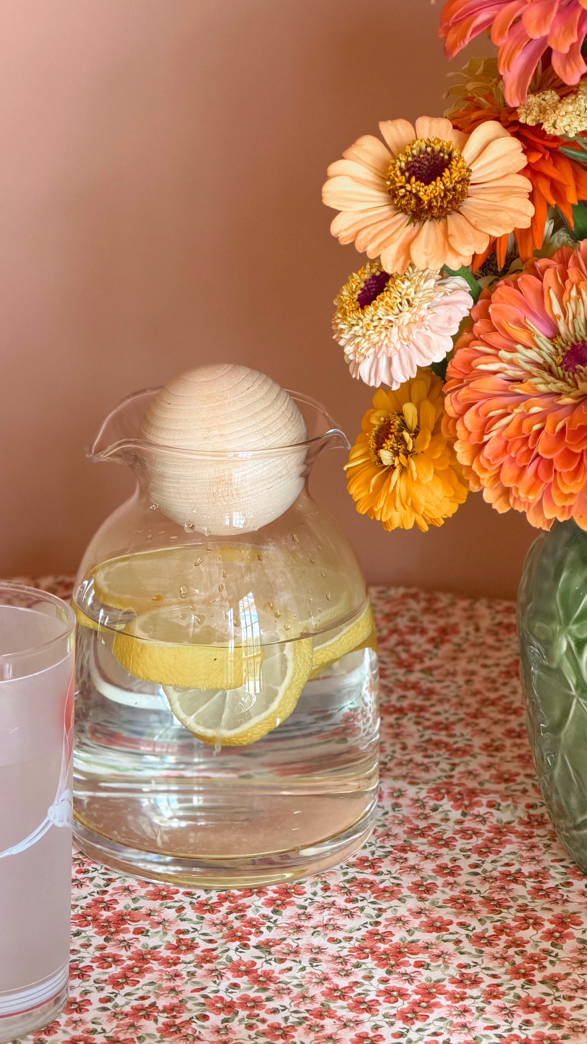 Vintage Clear Glass Double Spout Decanter with Ball Stopper on a cozy cottage table next to fresh flowers
