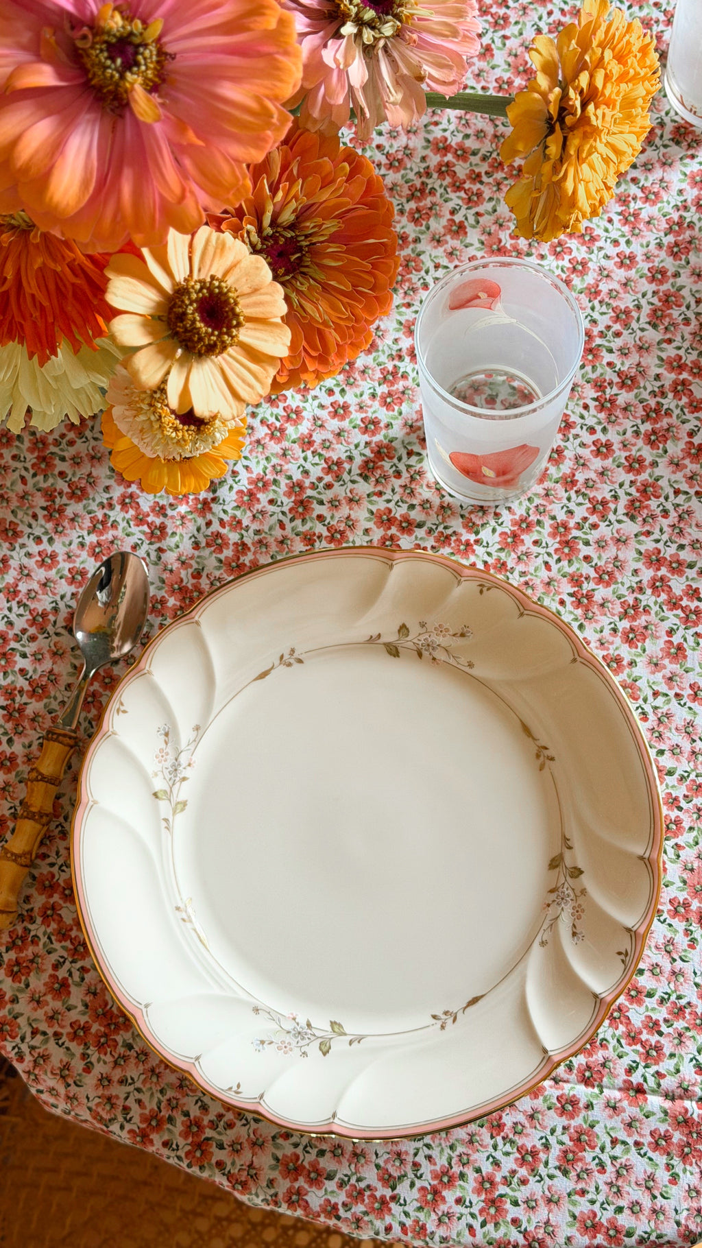 Vintage Mikasa Monticello dinner plate made in Japan with a delicate blush floral border and gold trim set on a cozy cottage table