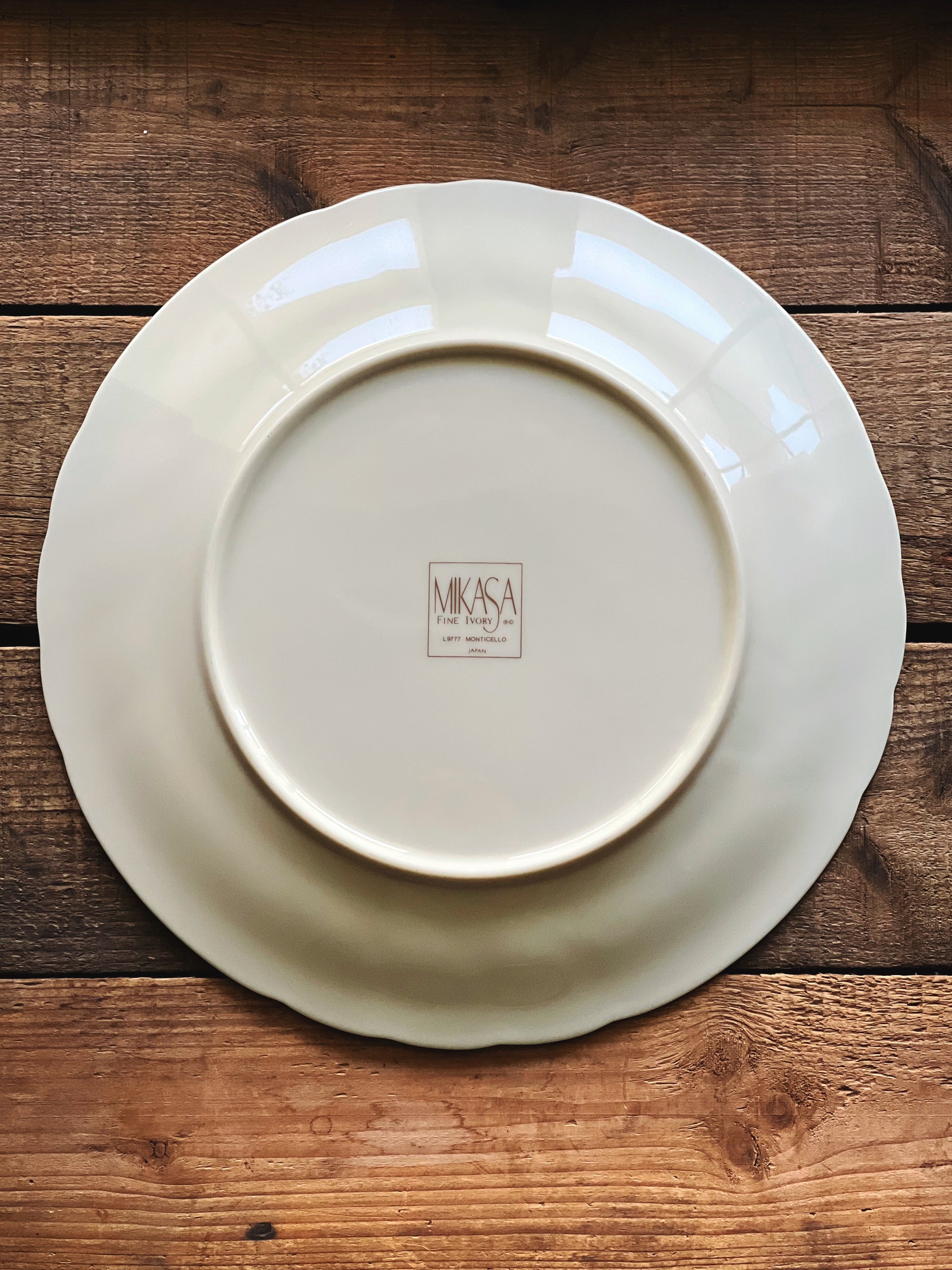 underside of a Vintage Mikasa Monticello dinner plate on a rustic wood surface