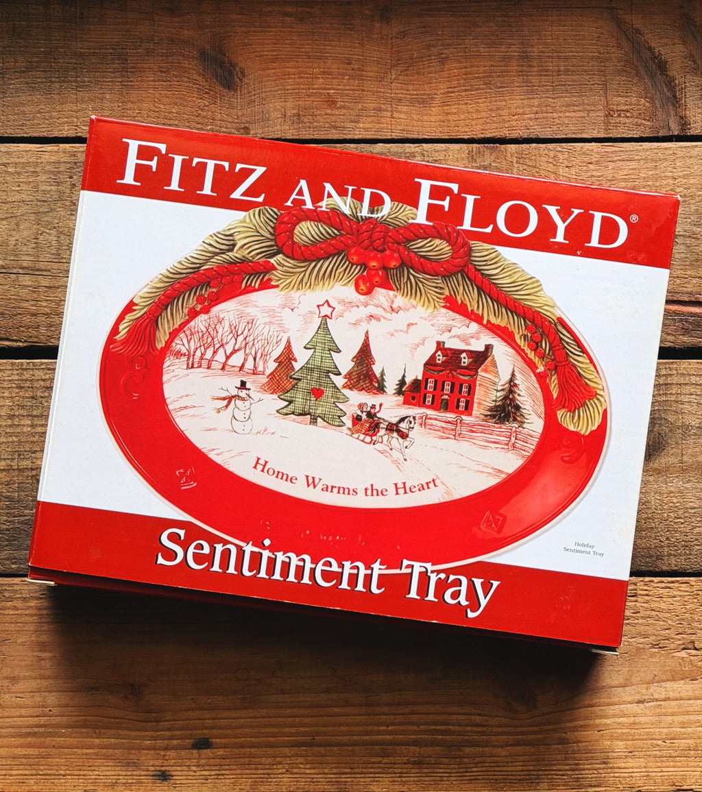 Fitz and Floyd Sentiment Tray gift box with a red and white holiday design, placed on a rustic wooden surface.