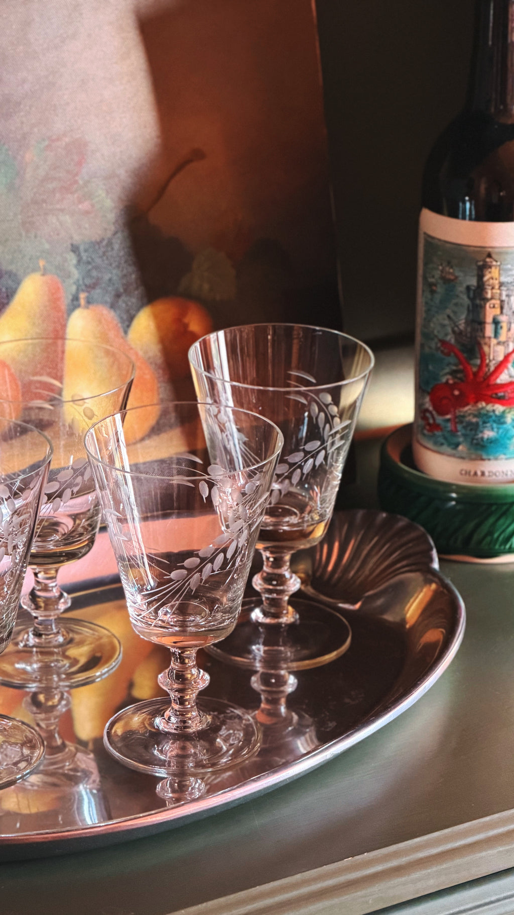 Set of 4 Vintage Etched Wine Glasses with Wheat Sheaf Design, arranged on a silver tray next to a wine bottle.