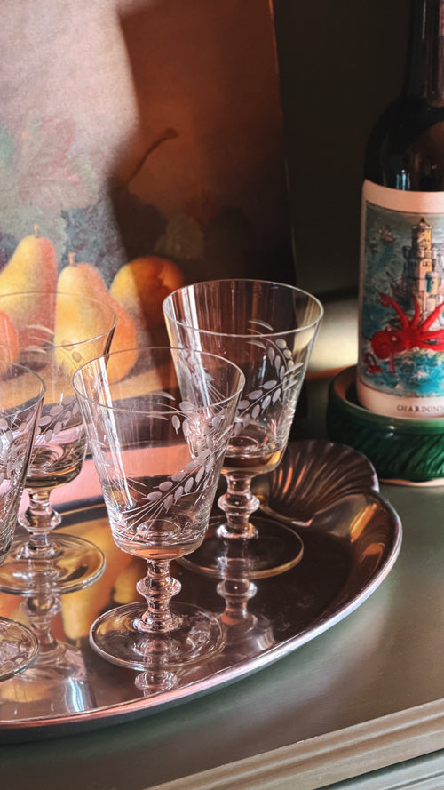 Set of 4 Vintage Etched Wine Glasses with Wheat Sheaf Design, arranged on a silver tray next to a wine bottle.