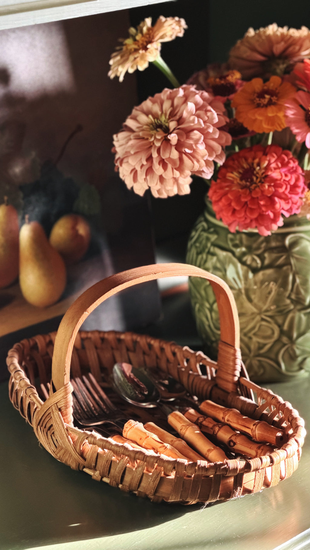 Vintage Woven Single-Handle Tabletop Basket on a shelf with fresh flowers