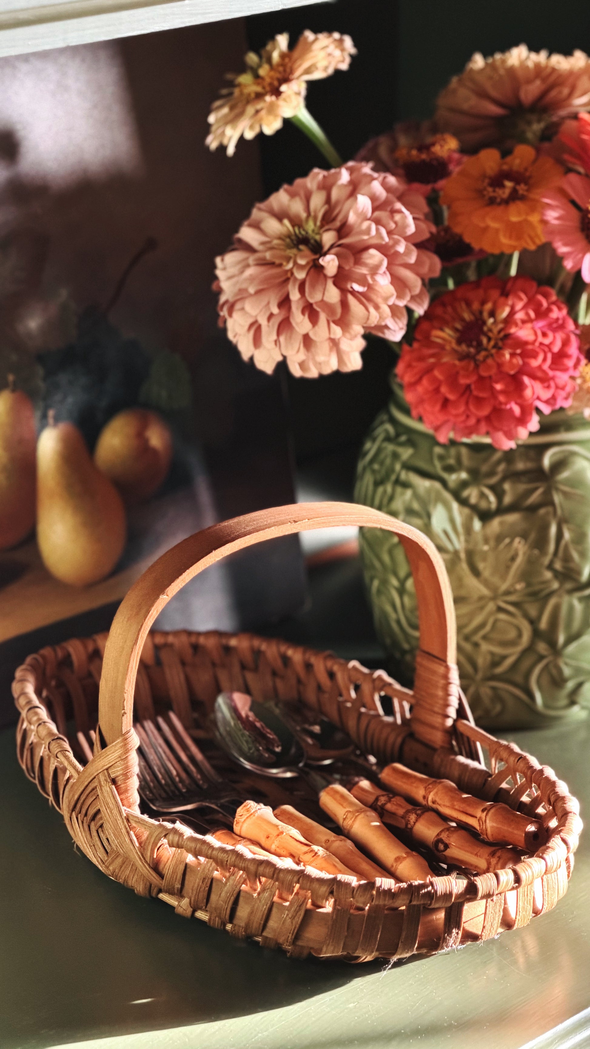 Vintage Woven Single-Handle Tabletop Basket on a shelf with fresh flowers