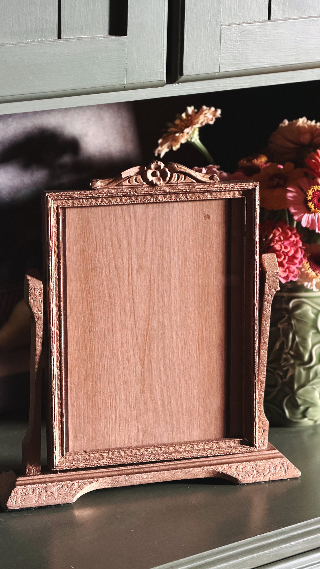 Vintage Gold-Toned Easel Picture Frame on a green shelf