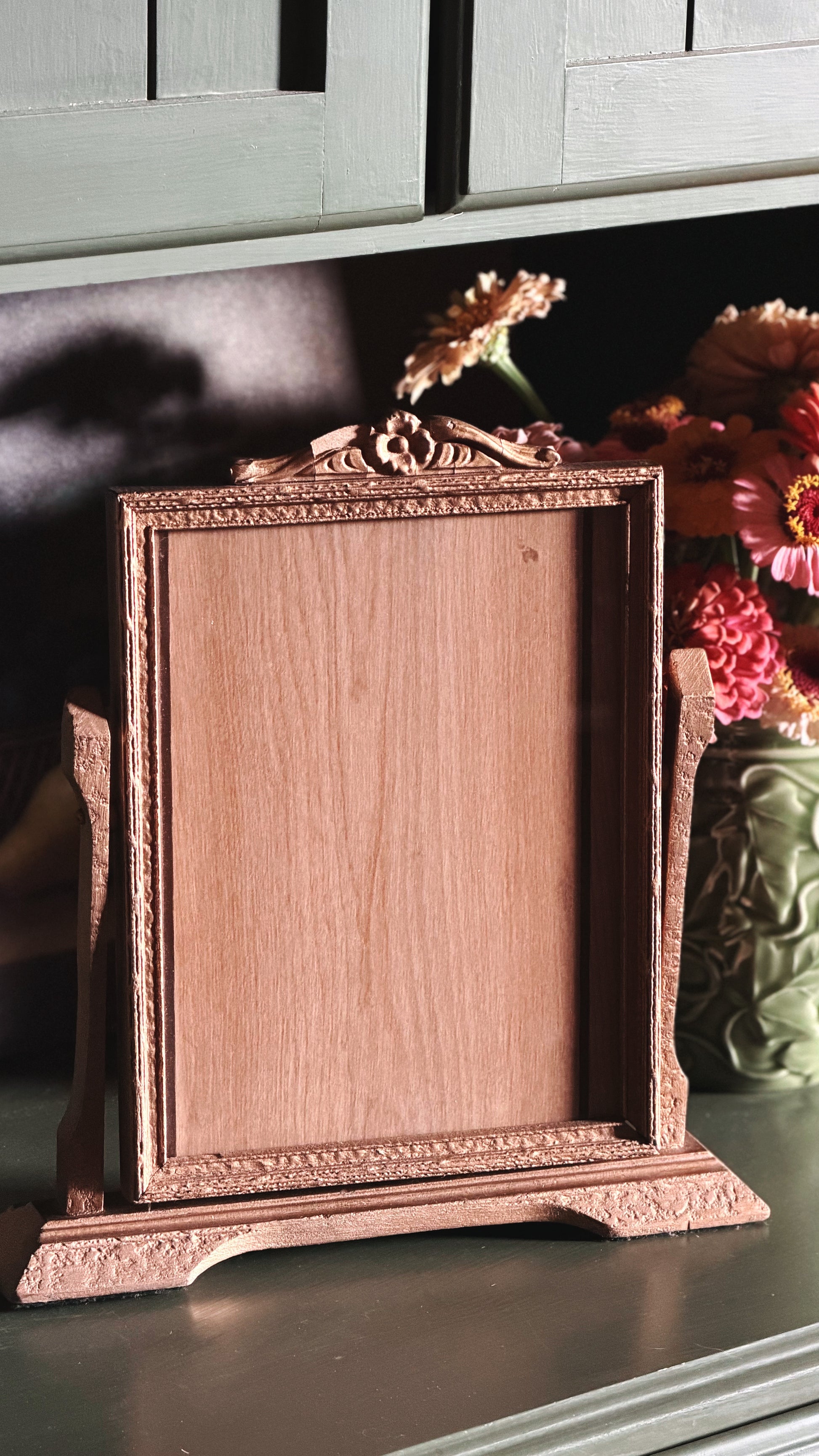 Vintage Gold-Toned Easel Picture Frame on a green shelf