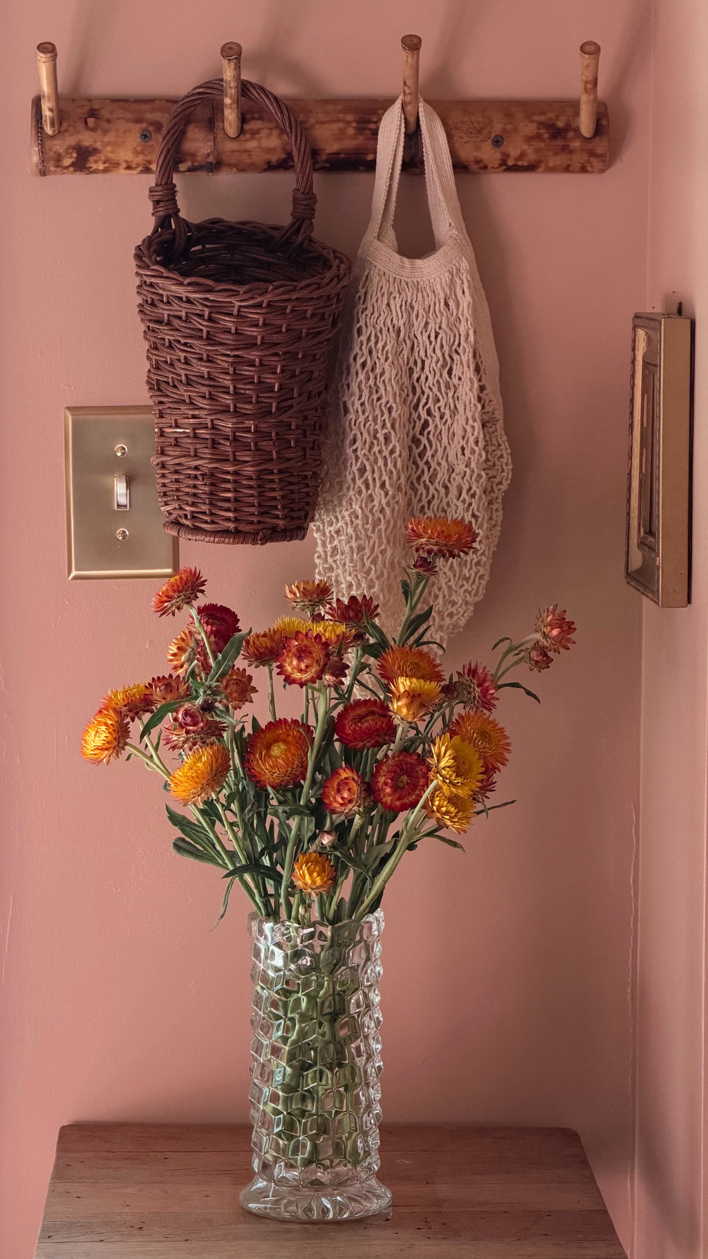 Vintage Fostoria American glass vase with colorful flowers in a collected interior