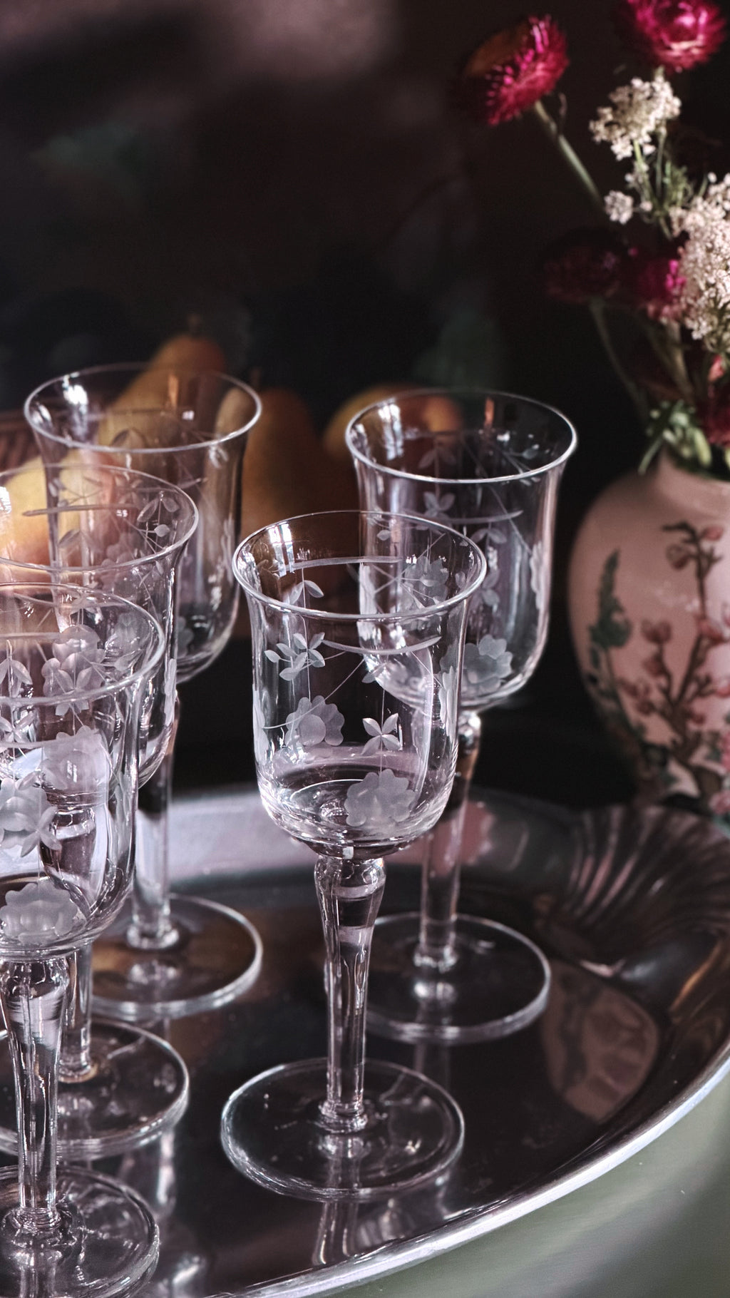 overhead angle of a set of Vintage Etched Crystal Tulip Wine Glasses on a silver tray