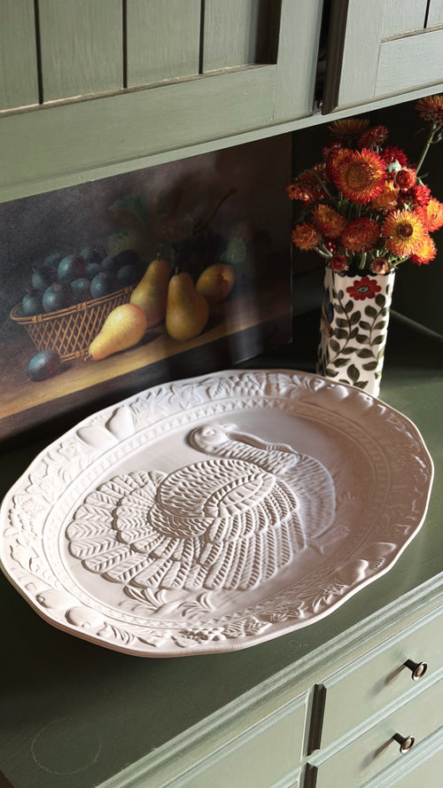 Embossed white turkey platter on a kitchen hutch