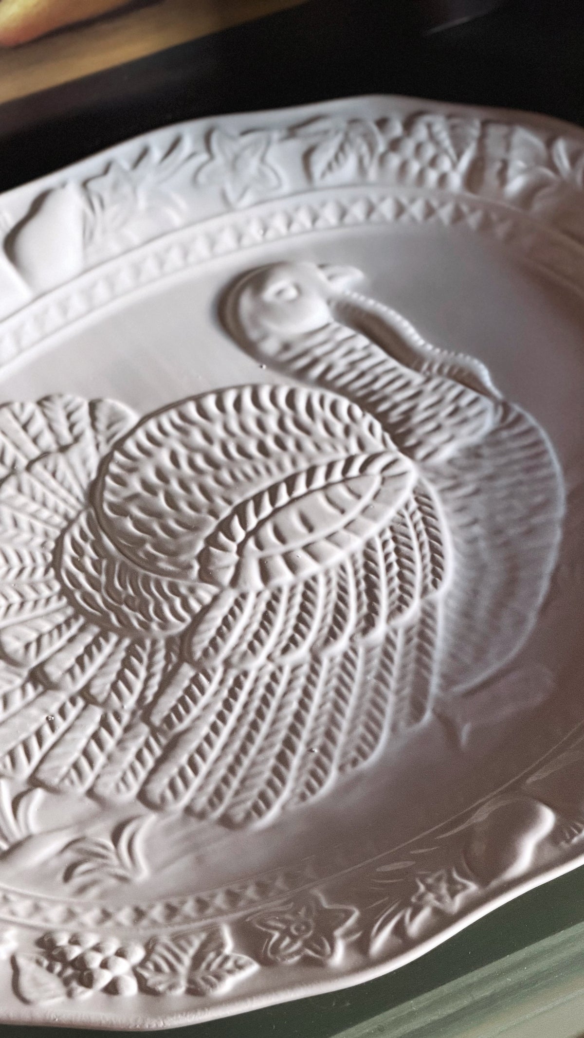 embossed detail of a ceramic turkey design