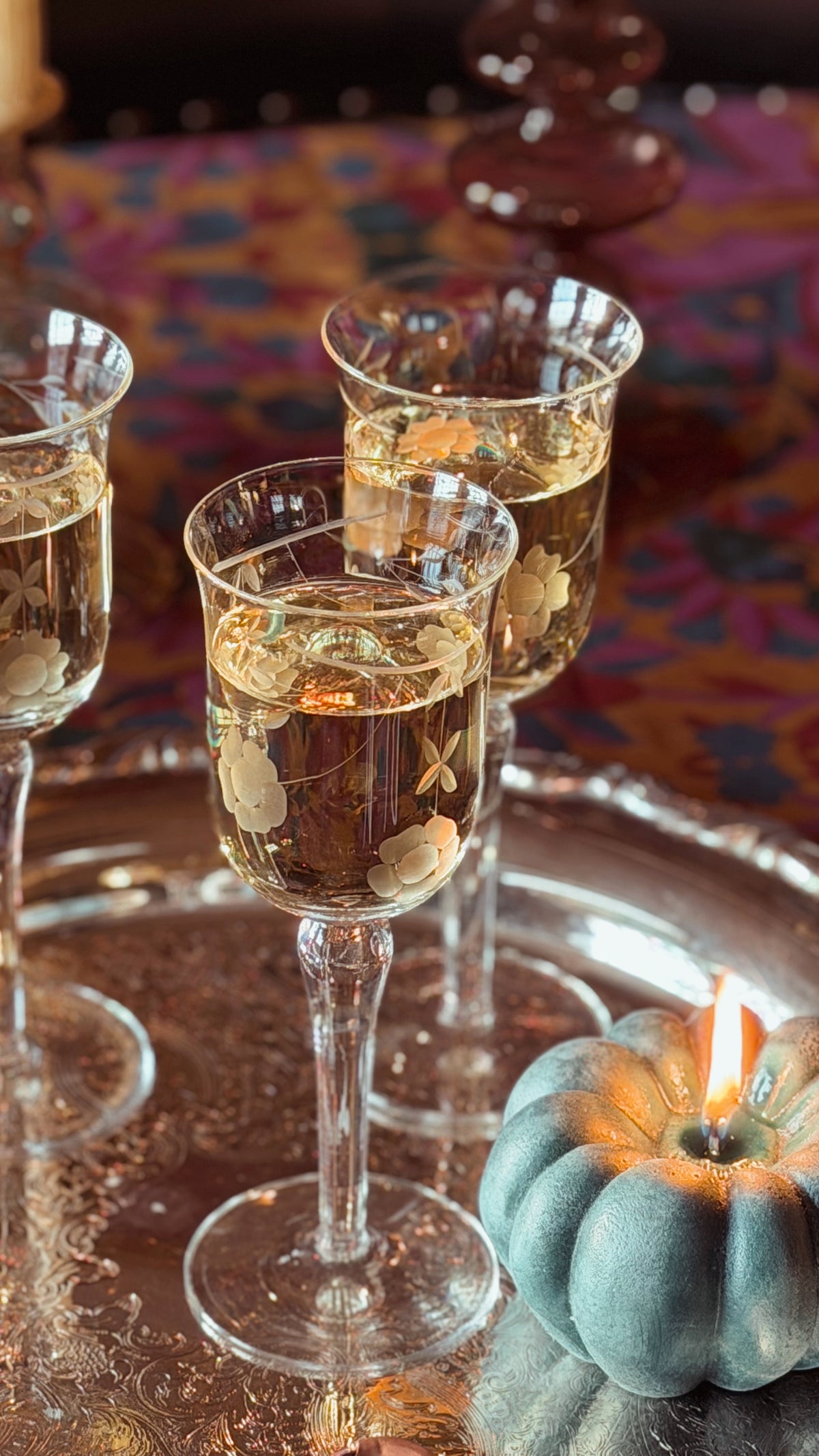 Vintage Etched Crystal Tulip Wine Glasses on a silver tray filled with wine